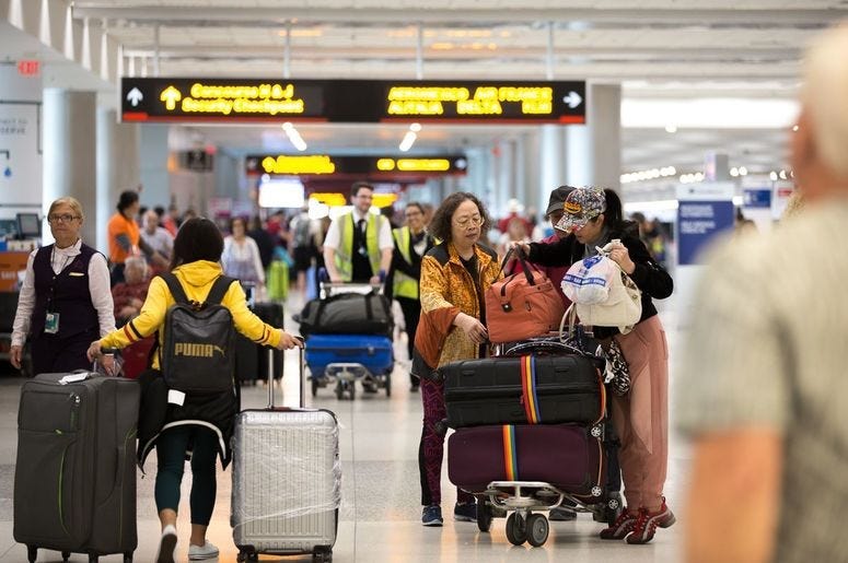 Passengers prepare to check in at Miami International Airport
