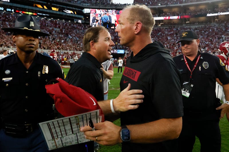 Oct 26, 2024; Tuscaloosa, Alabama, USA; Missouri Tigers head coach Eliah Drinkwitz (left) talks with Alabama Crimson Tide head coach Kalen DeBoer (right) after a game at Bryant-Denny Stadium. Mandatory Credit: Butch Dill-Imagn Images