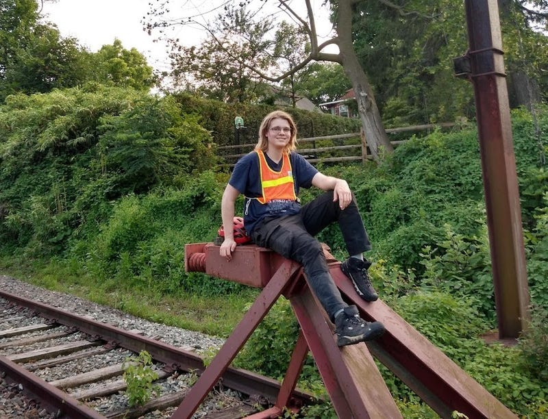 Alex Davis sitting atop the bumper post of SEPTA's currently suspended Cynwyd Line.
