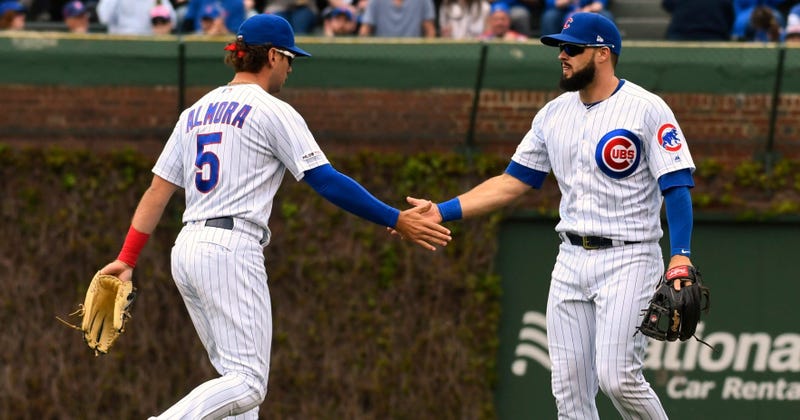 Cubs infielder David Bote (13) reacts with outfielder Albert Almora Jr. (5) after catching a fly ball.