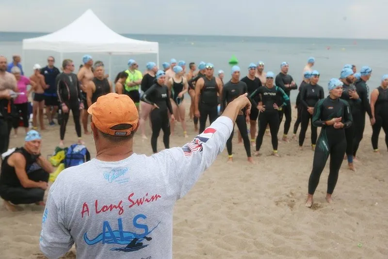 Doug McConnell, of the nonprofit A Long Swim, directs a group of swimmers about to participate in one of the organization's open water fundraiser swims. This September, the group will host a historic swim event on the Chicago River.