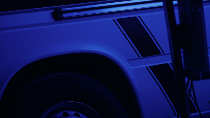 Ambulance with emblem in dark - stock photo