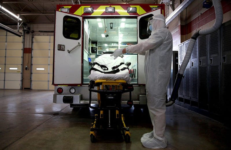 Healthcare worker prepares to pickup a patient with covid-19