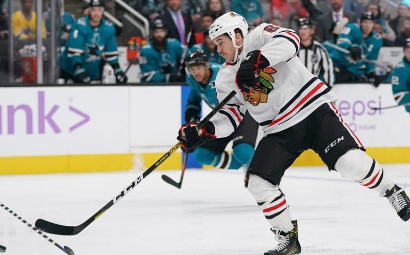 Blackhawks center Andrew Shaw (65) shoots the puck against the Sharks.