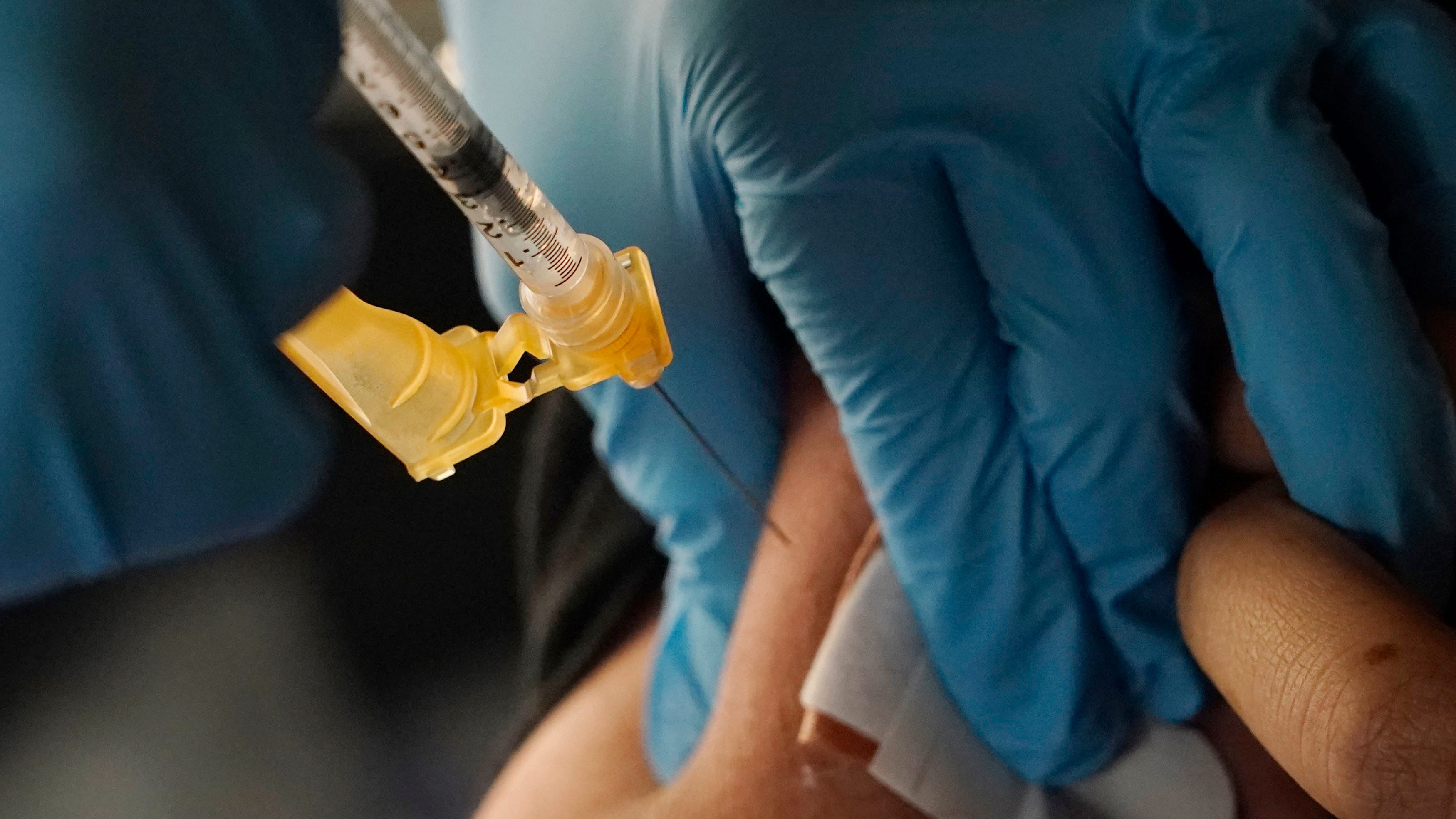 FDA clears extra COVID booster for some high-risk Americans