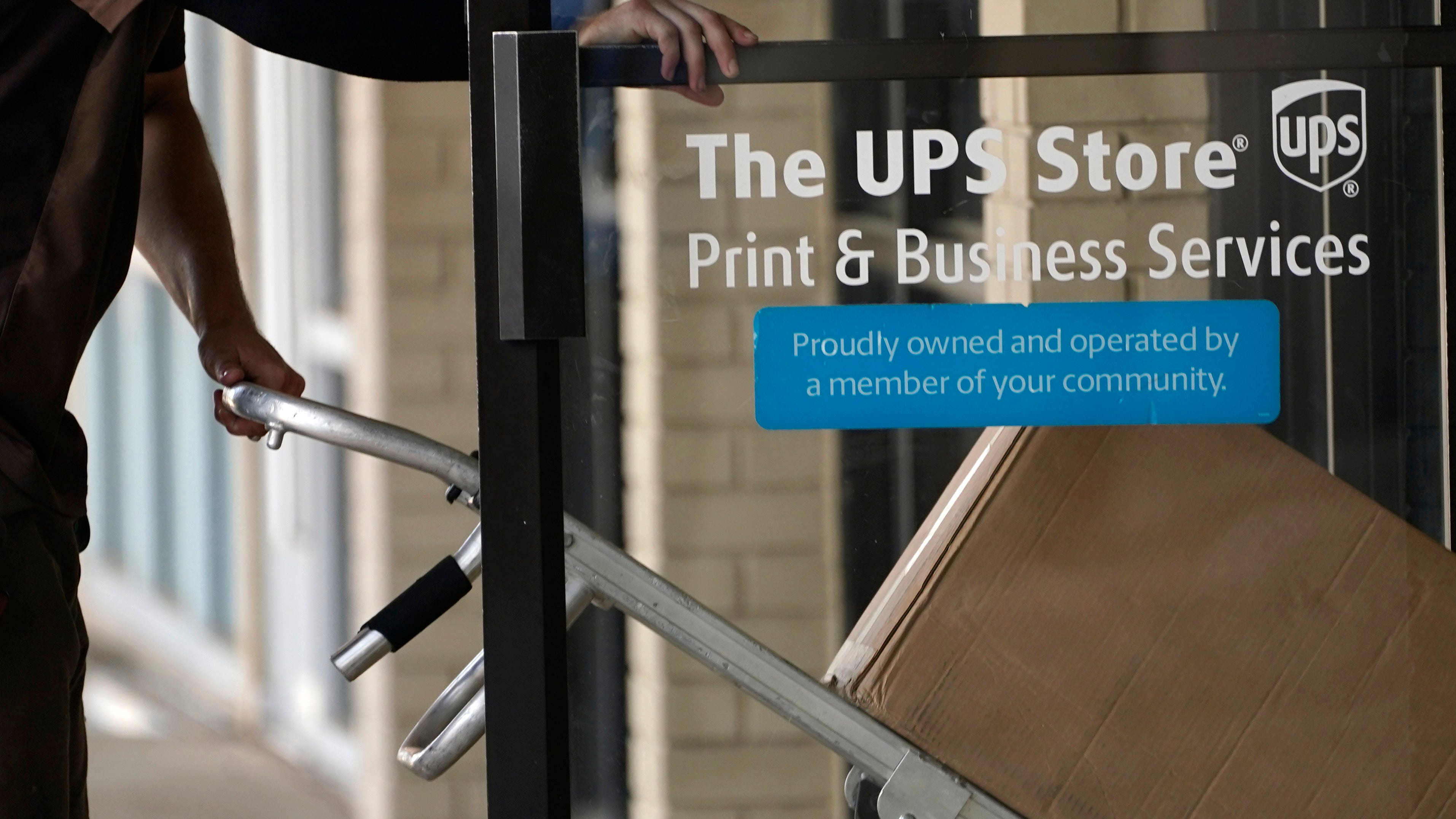 UPS earns $2.7 billion but volume dips as stores reopen