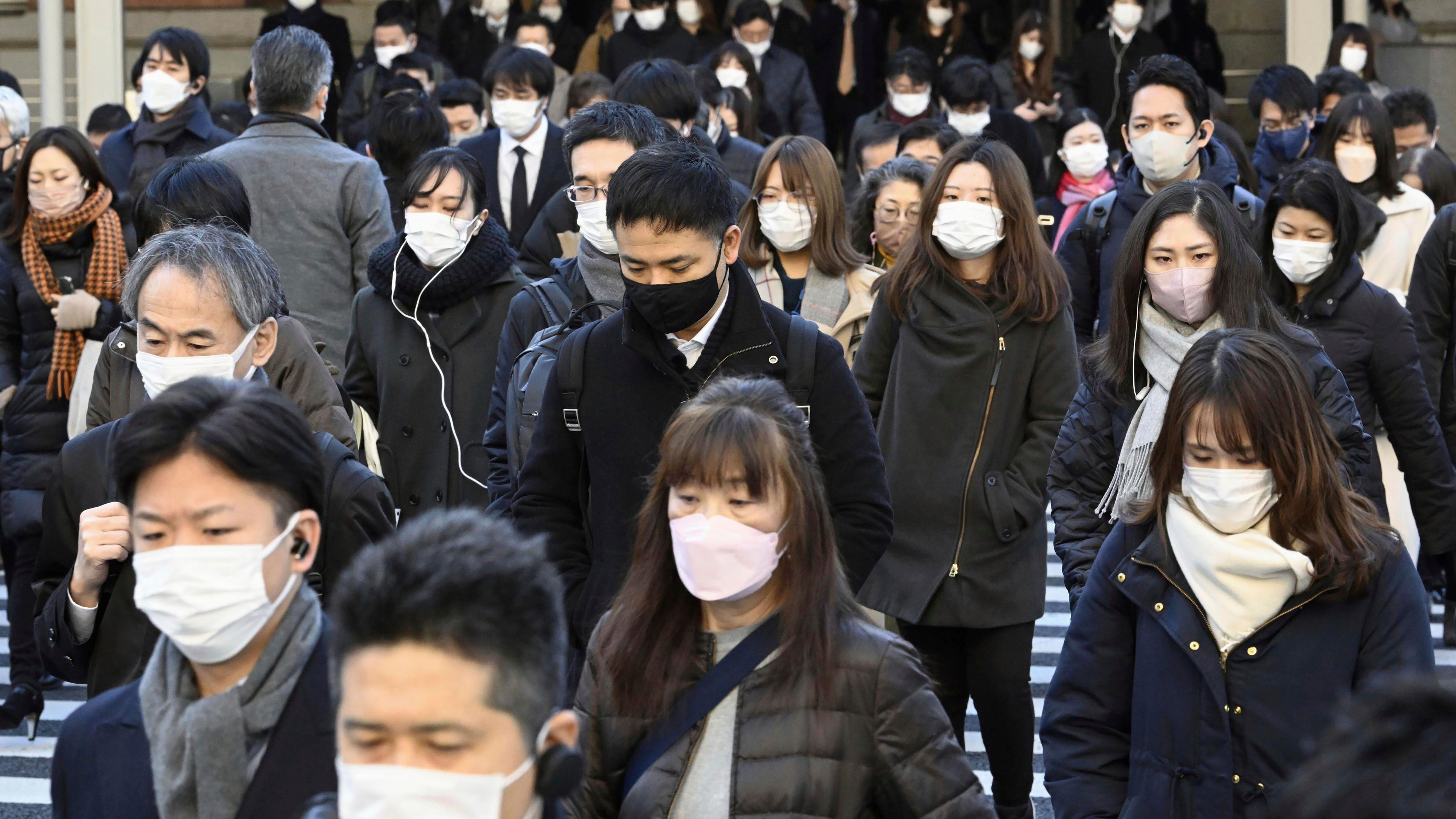 Japan to lower COVID-19 to flu status, further easing rules