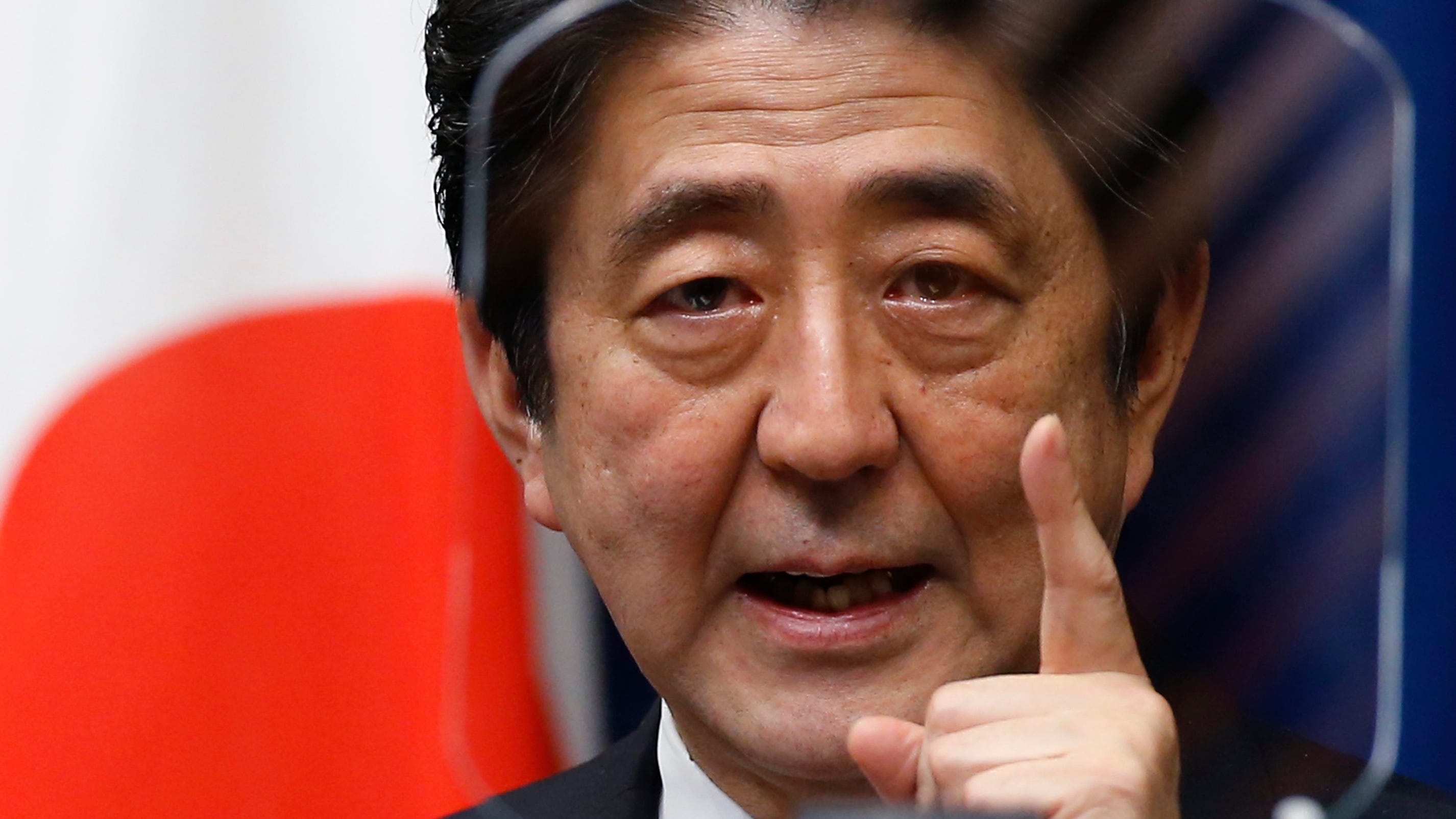 Shinzo Abe, powerful former Japan PM, leaves divided legacy