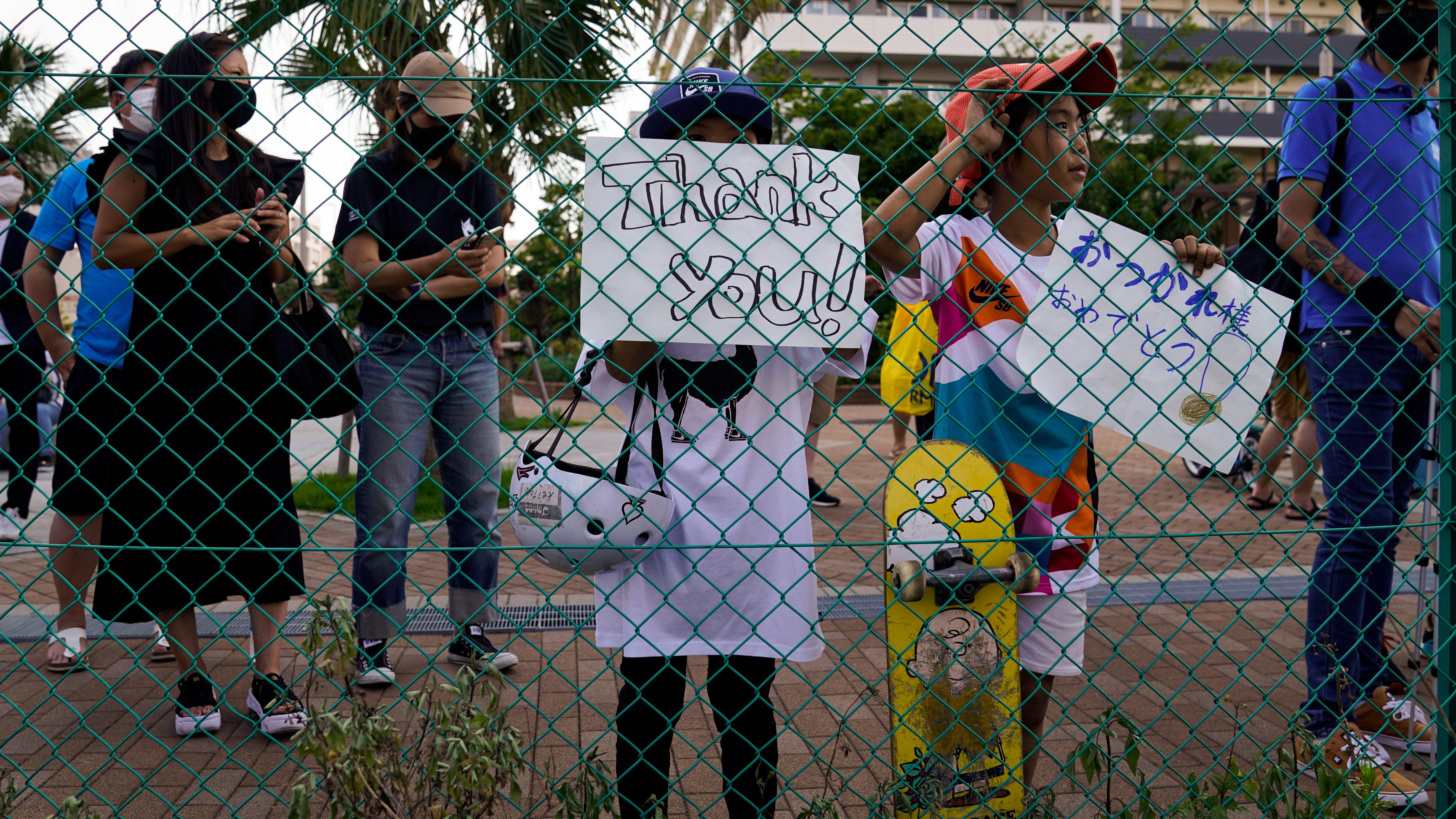 Sneaking a peek: Fans find creative ways to glimpse Olympics