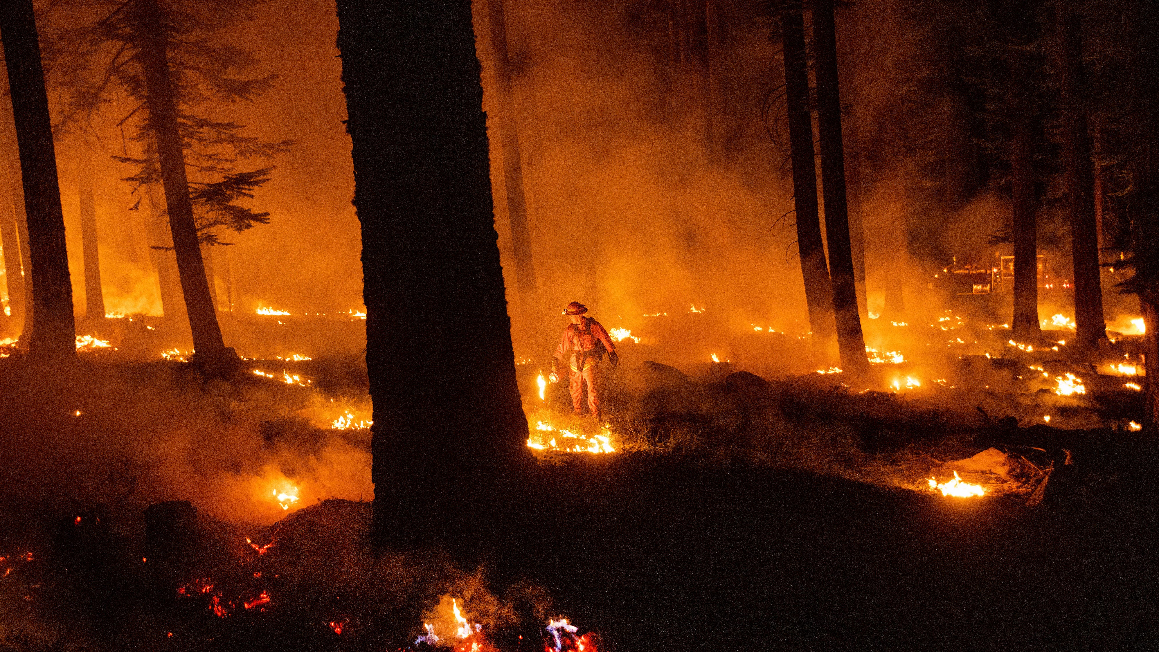 Western wildfires calm down in cool weather, but losses grow