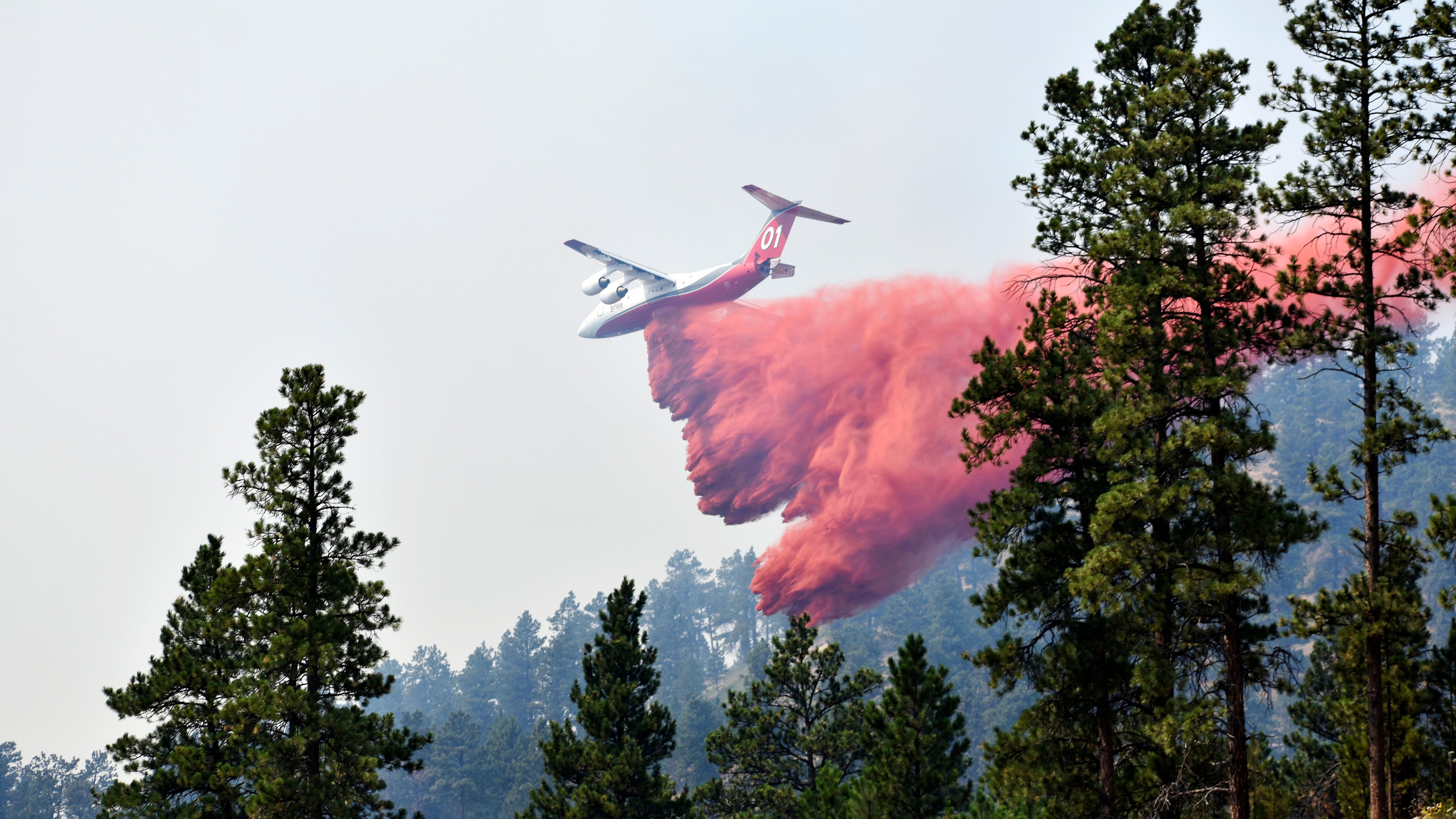 Wildfire bears down on Montana towns as West burns