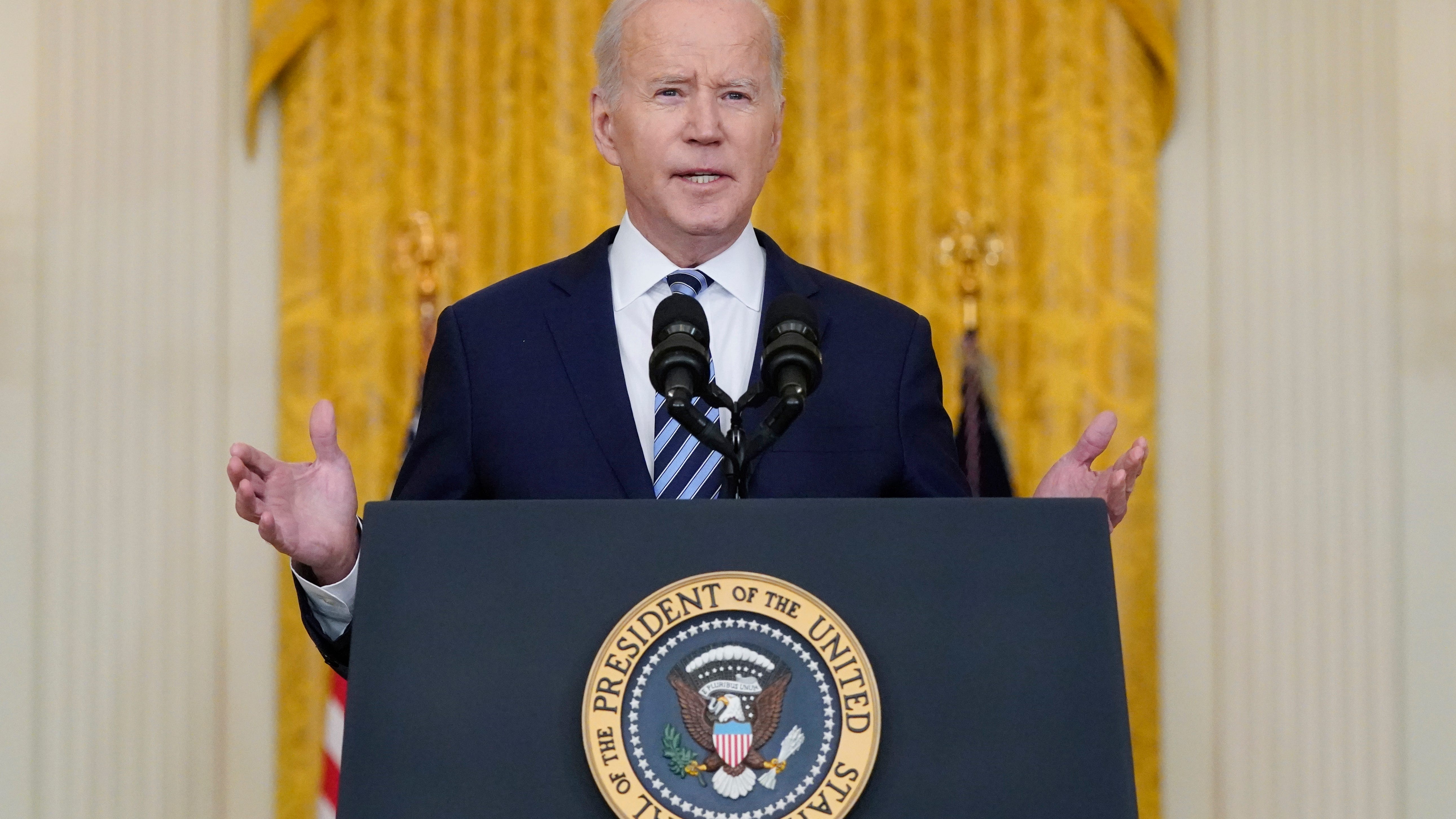 Biden hits Russia with sanctions, shifts troops to Germany
