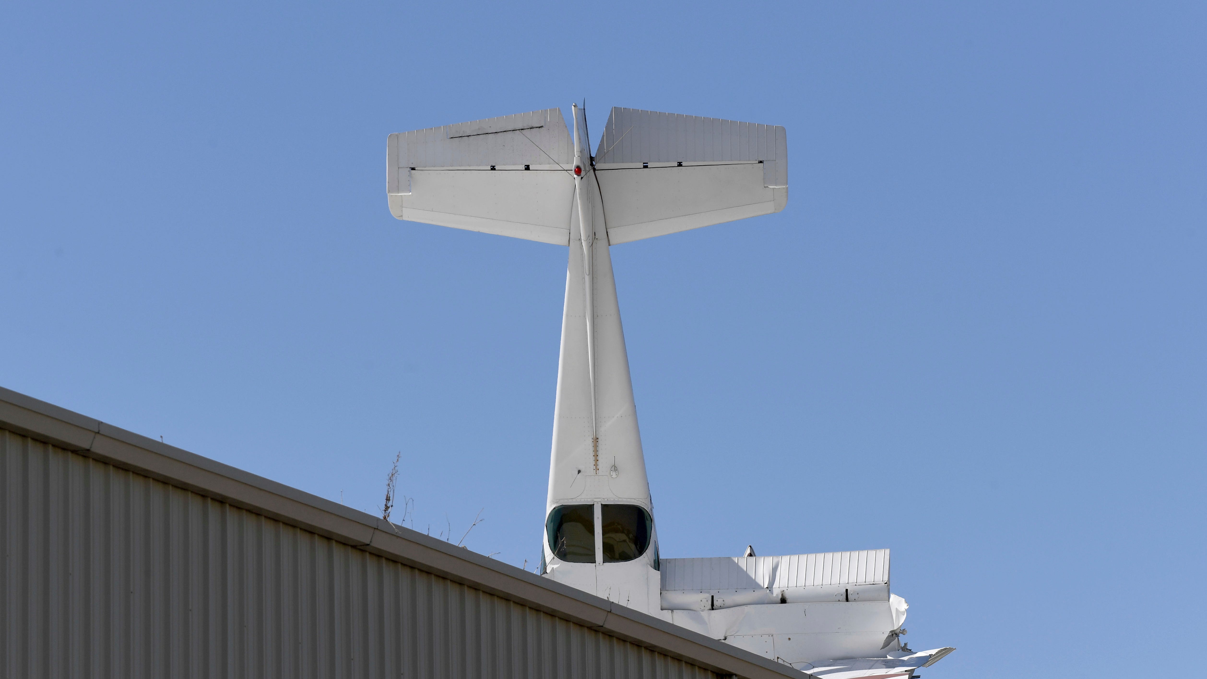 Pilot escapes with minor injuries when small plane crashes into hangar's roof at California airport