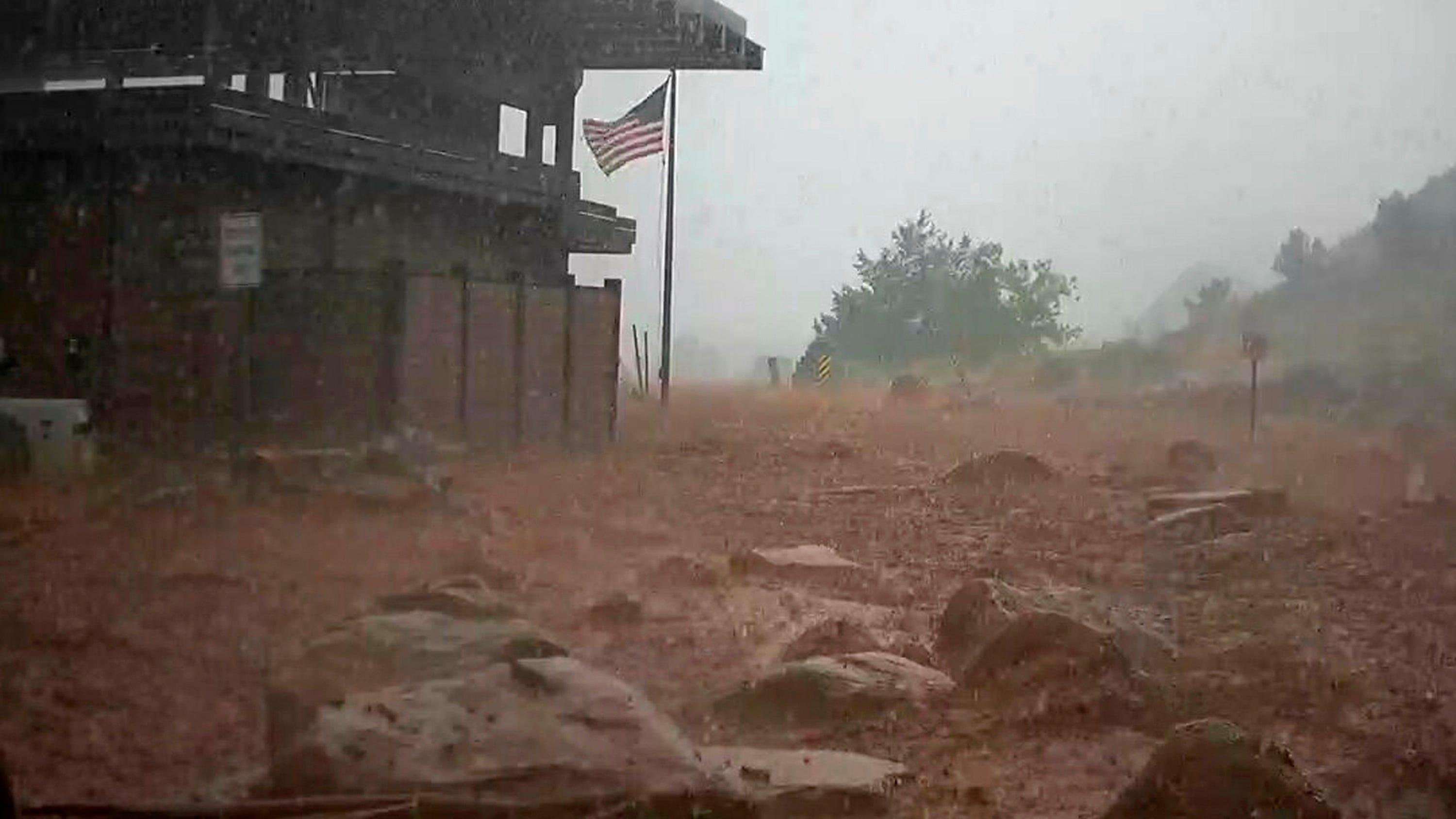 Arizona levee breached, hiker missing after floods hit West