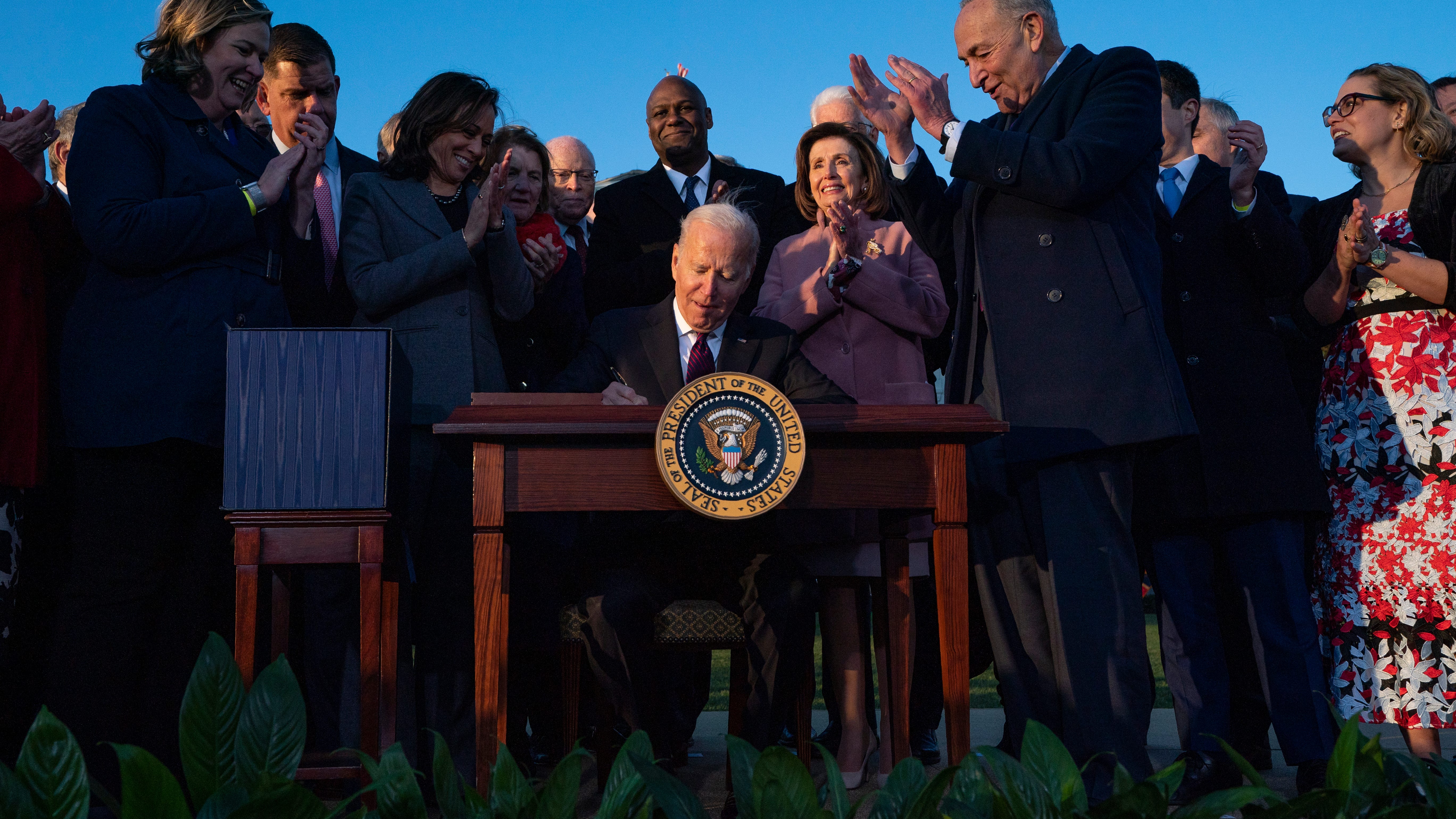 Biden signs $1T infrastructure deal with bipartisan crowd