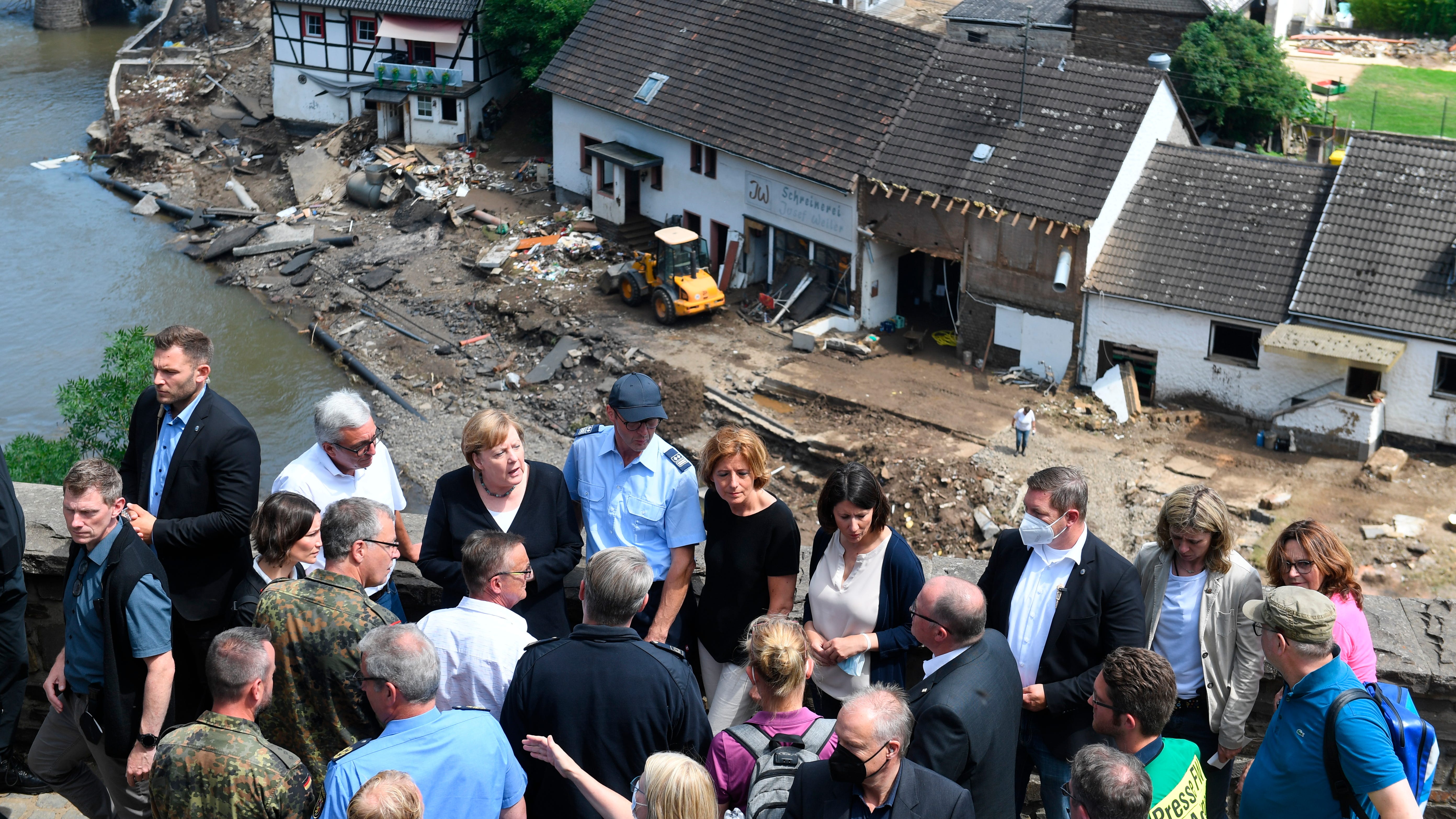 Merkel tours 'surreal' flood scene, vows aid, climate action