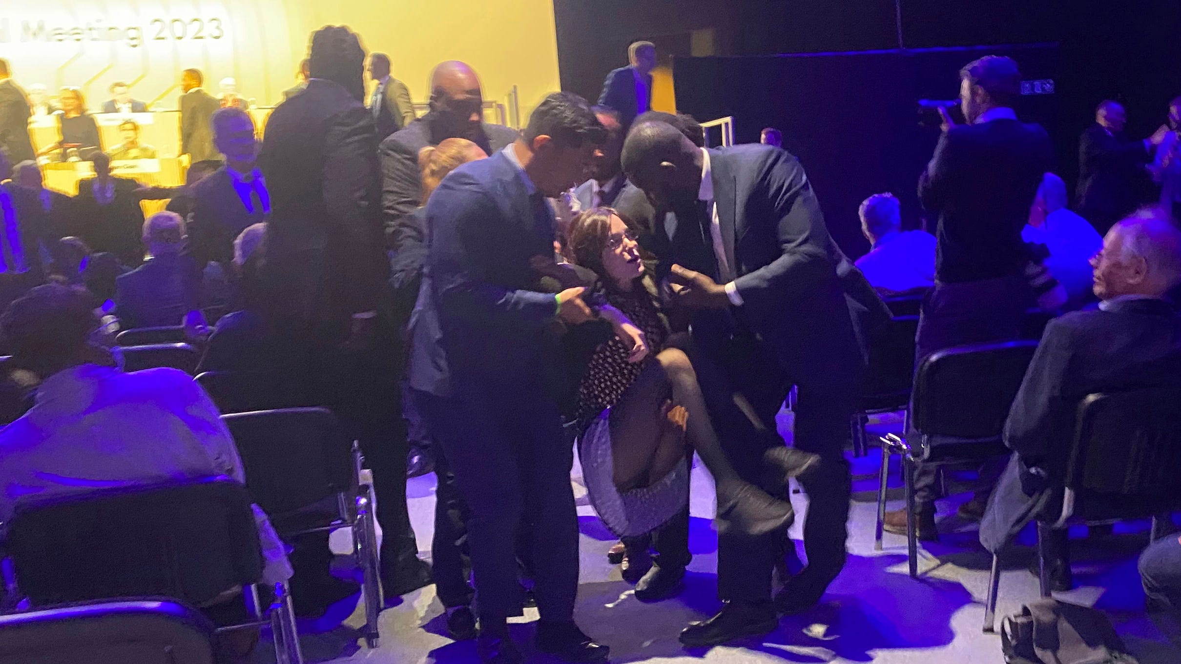 Climate protesters dragged from Shell shareholder meeting as they rush stage