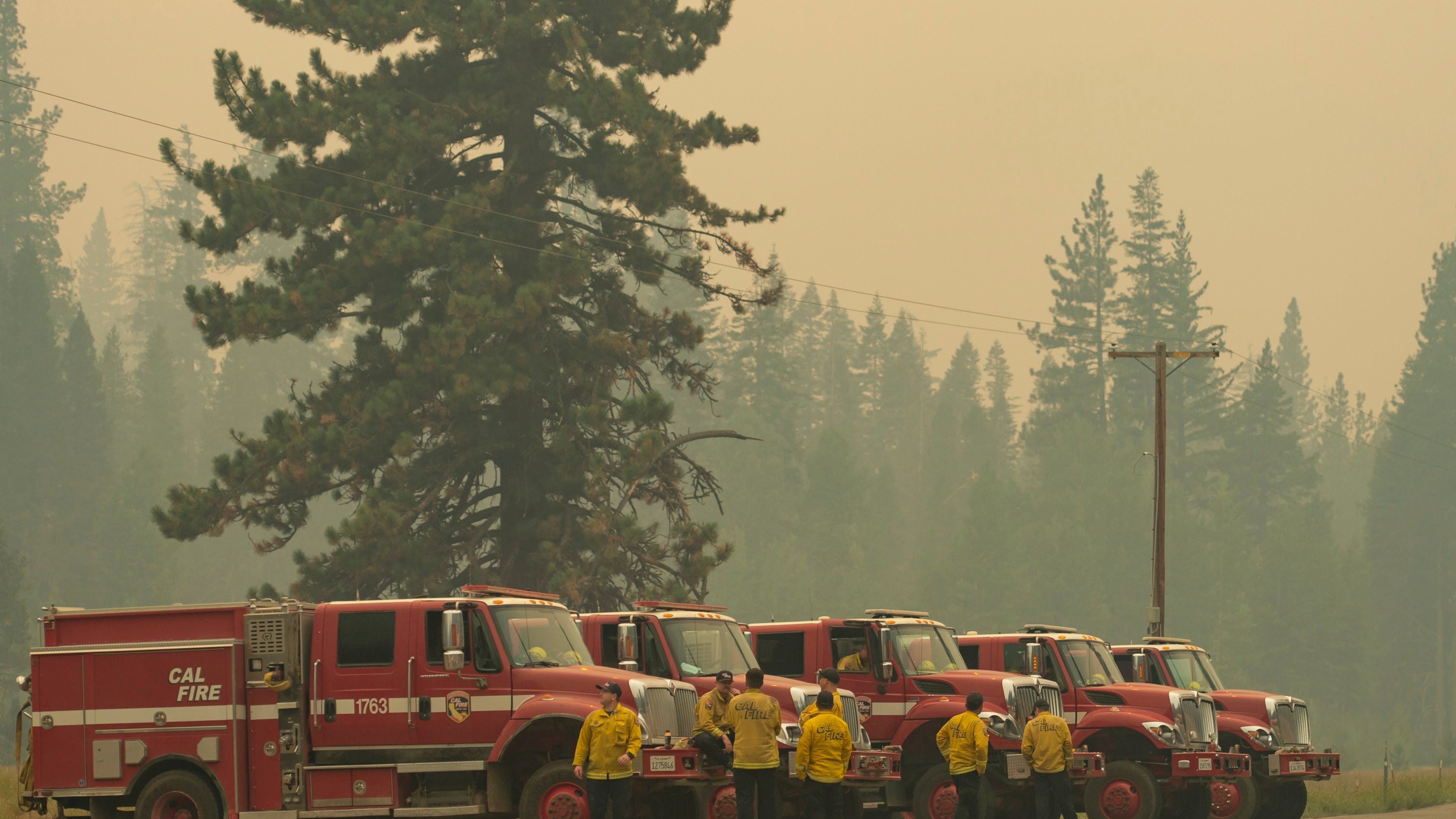 California firefighters battle a dozen large wildfires