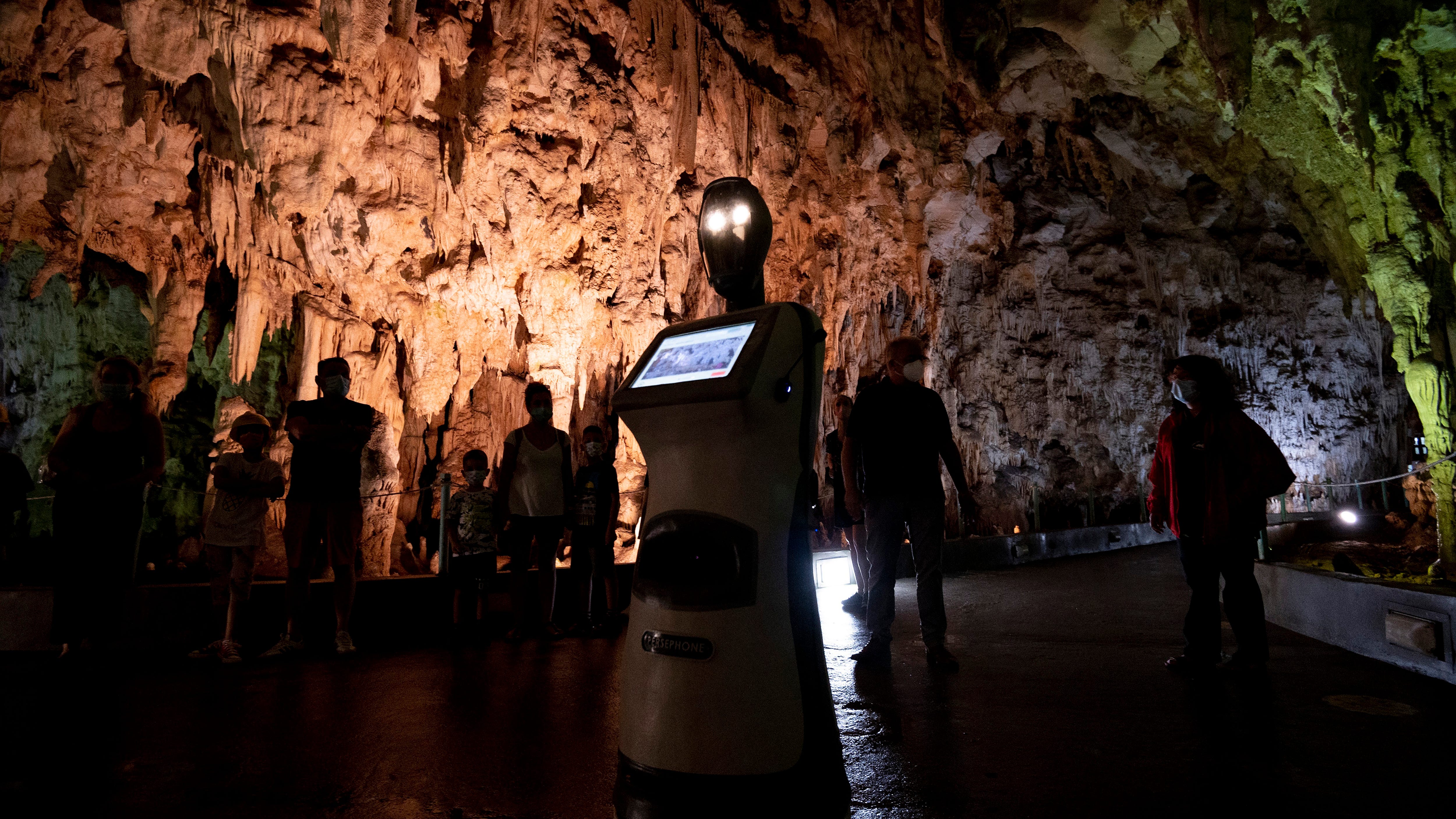 Persephone, the robot guide, leads visitors in a Greek cave
