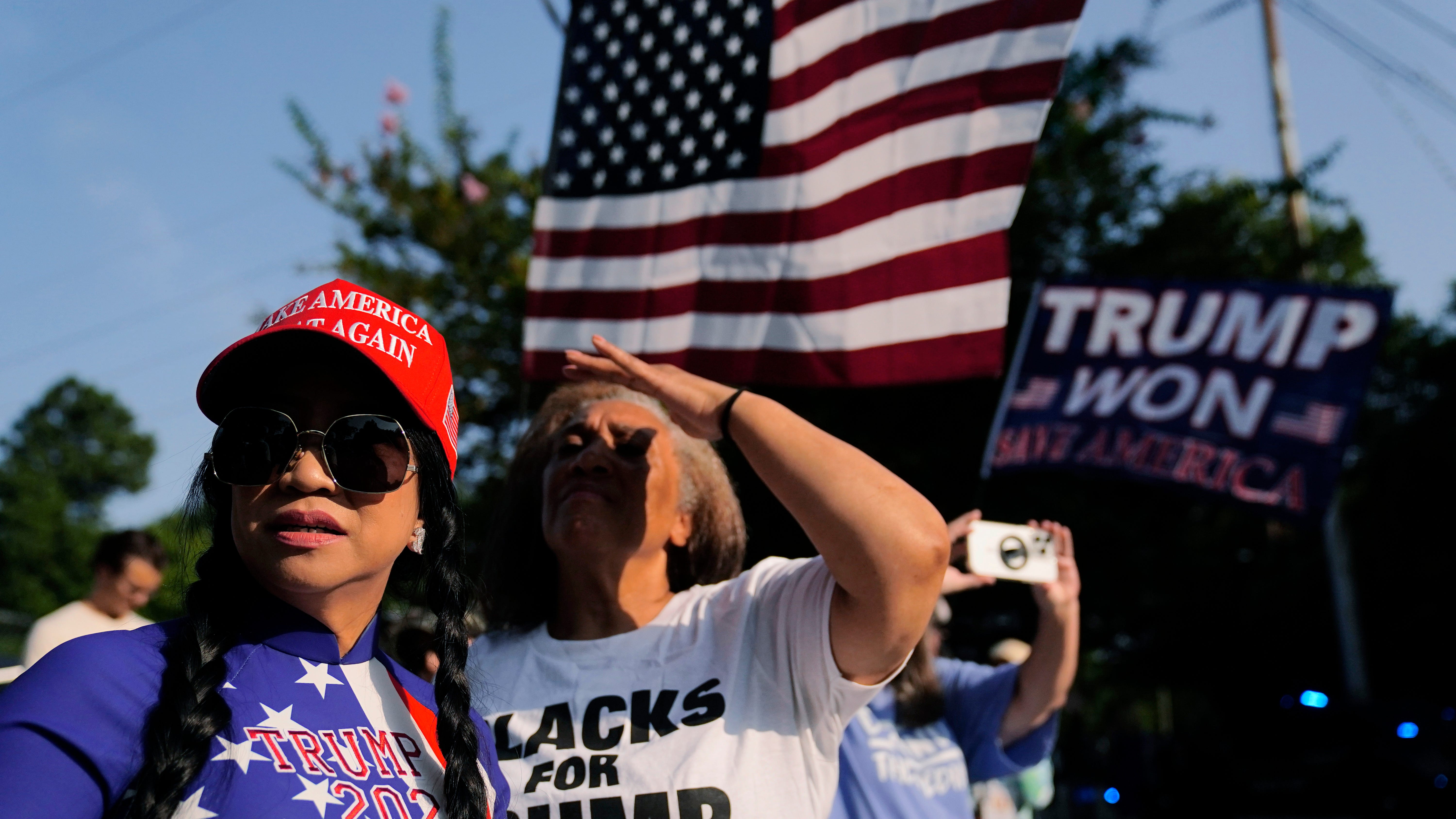 Dozens of Trump supporters cheer him on as former president turns himself in at Georgia jail