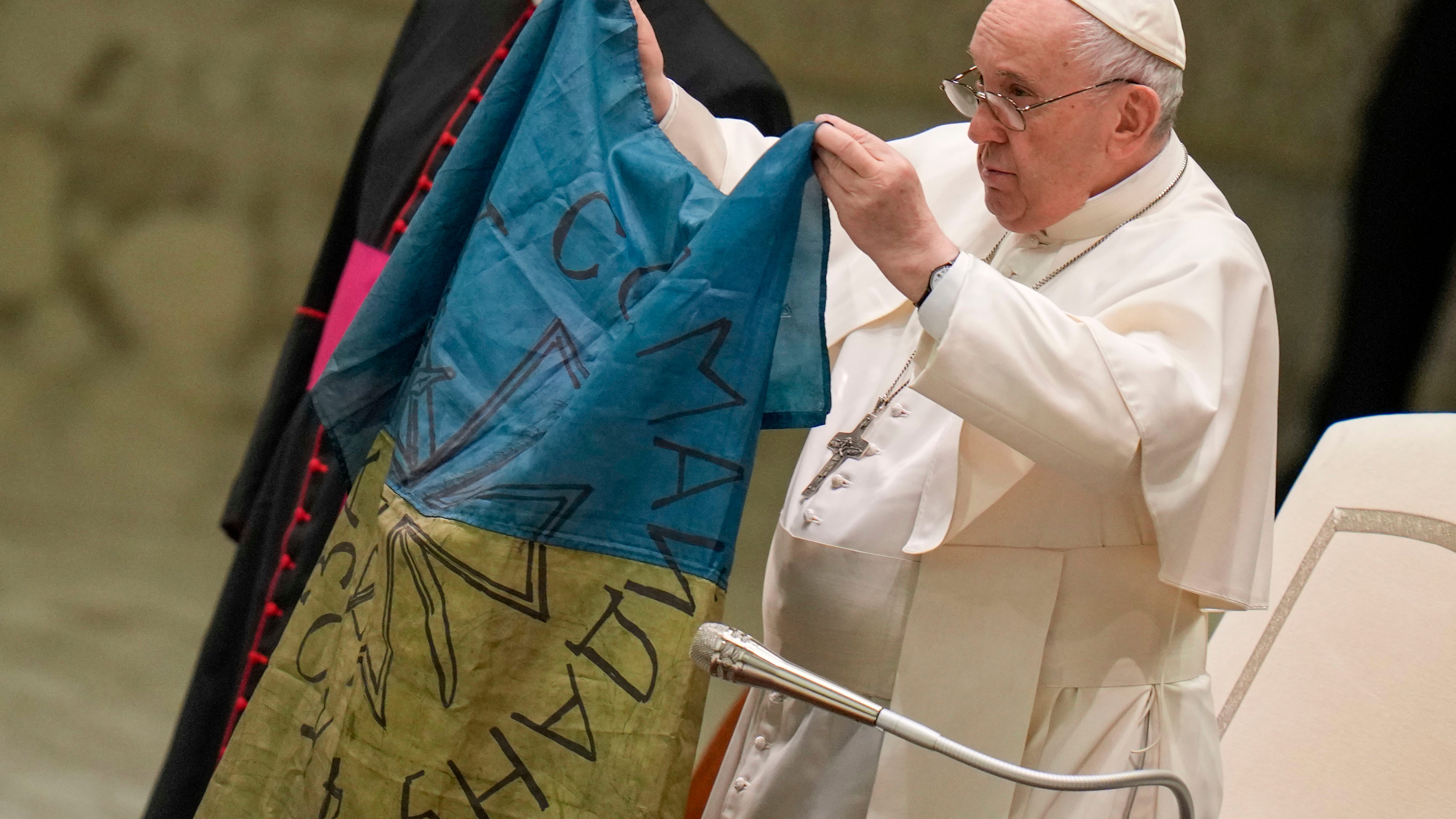 Pope Francis kisses Ukrainian flag from 'martyred' Bucha