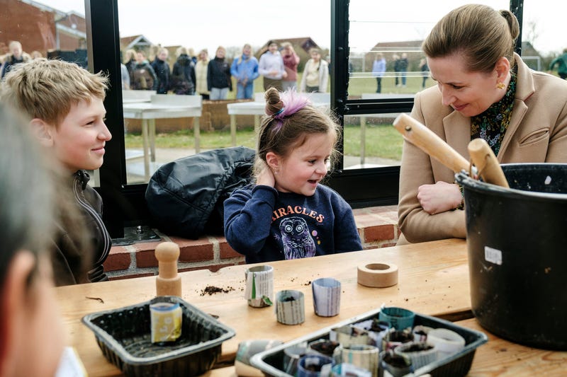 FILE - Danish Prime Minister Mette Frederiksen, right, meets Ukrainian refugee children at Paradisbakken school in Nexoe, as she visits the island of Bornholm in Denmark, Thursday, April 7, 2022. Anna Prokopiuk, center, is from Ukraine but has lived in Denmark for three years and is therefore able to help interpret for the newly arrived refugees.