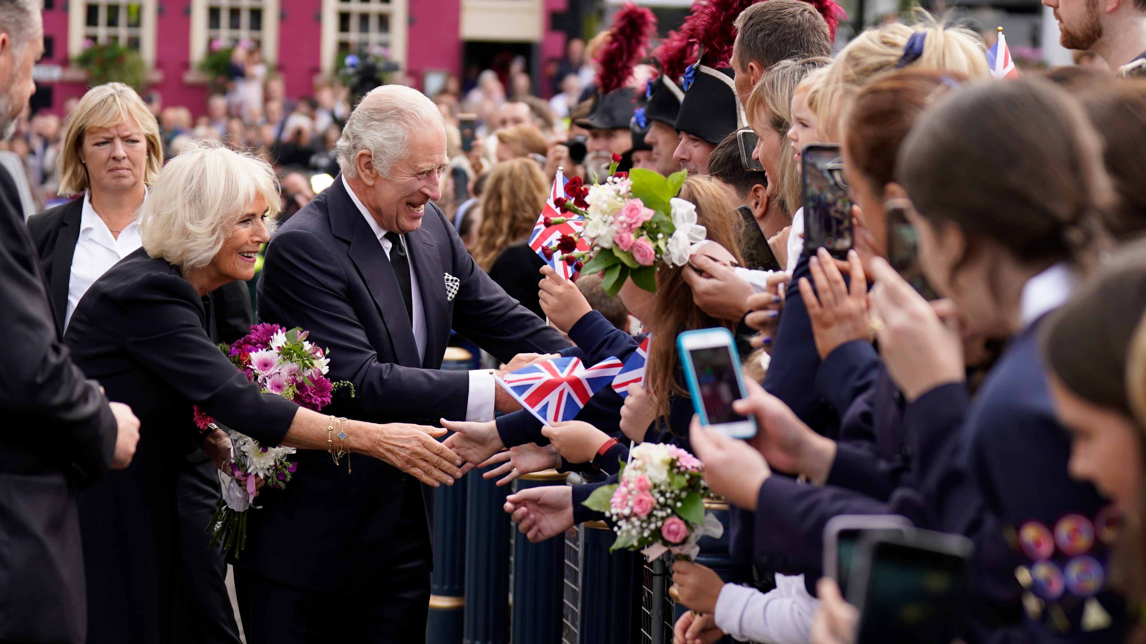 King cheered in Belfast, queen's coffin to return to London