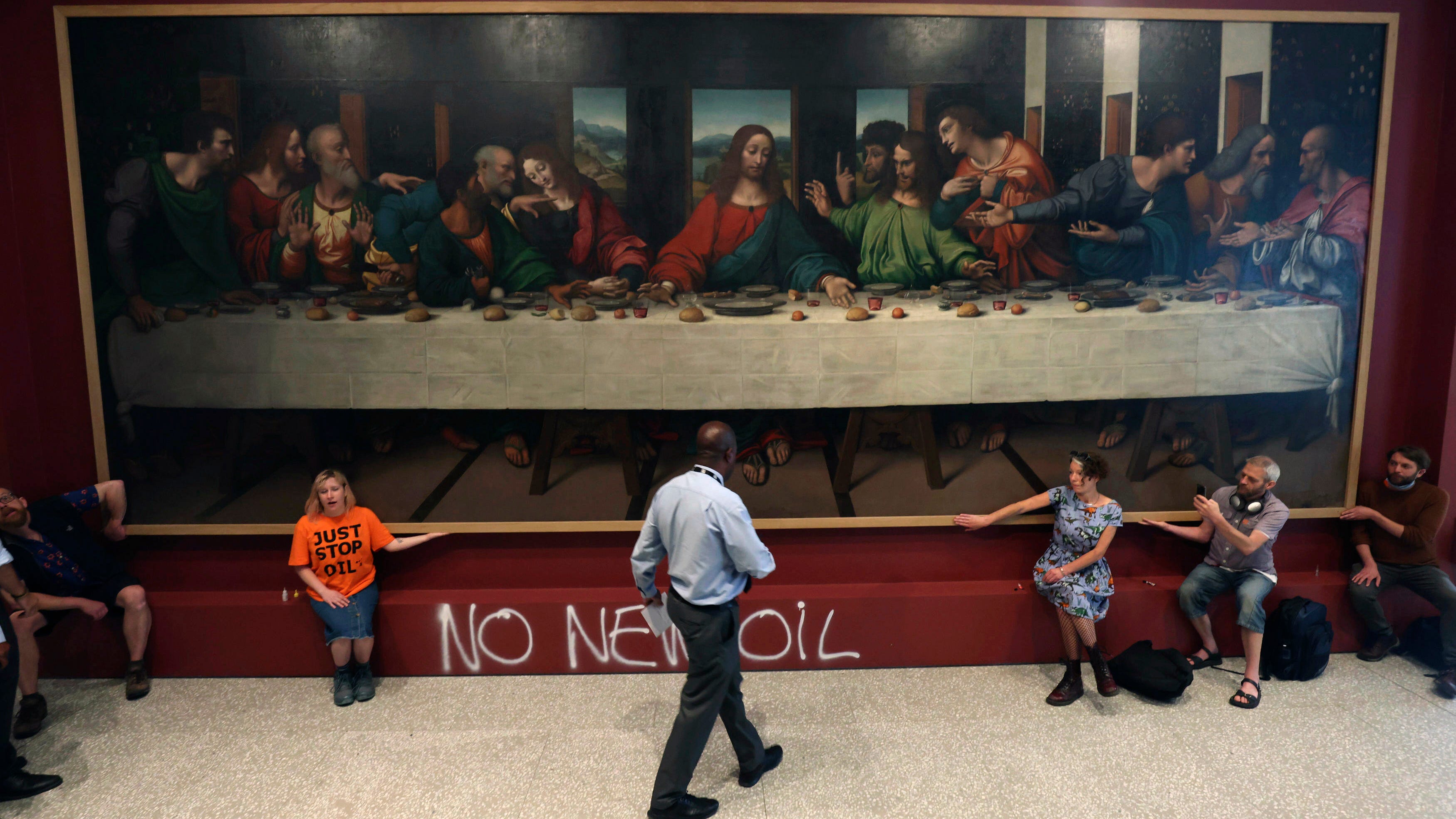 UK climate protesters glue themselves to gallery paintings