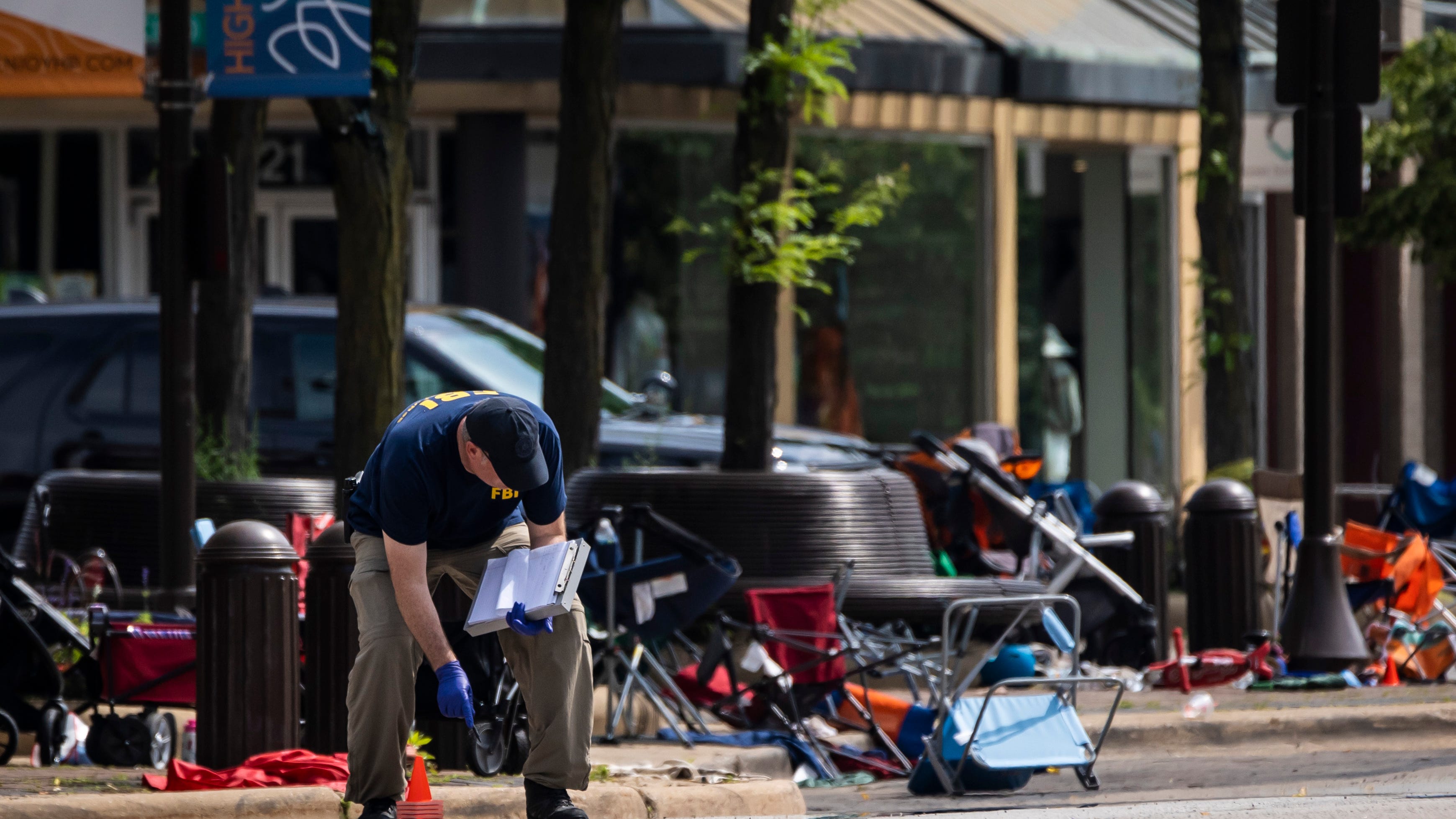 Parents of boy, 2, found alone at parade shooting among dead
