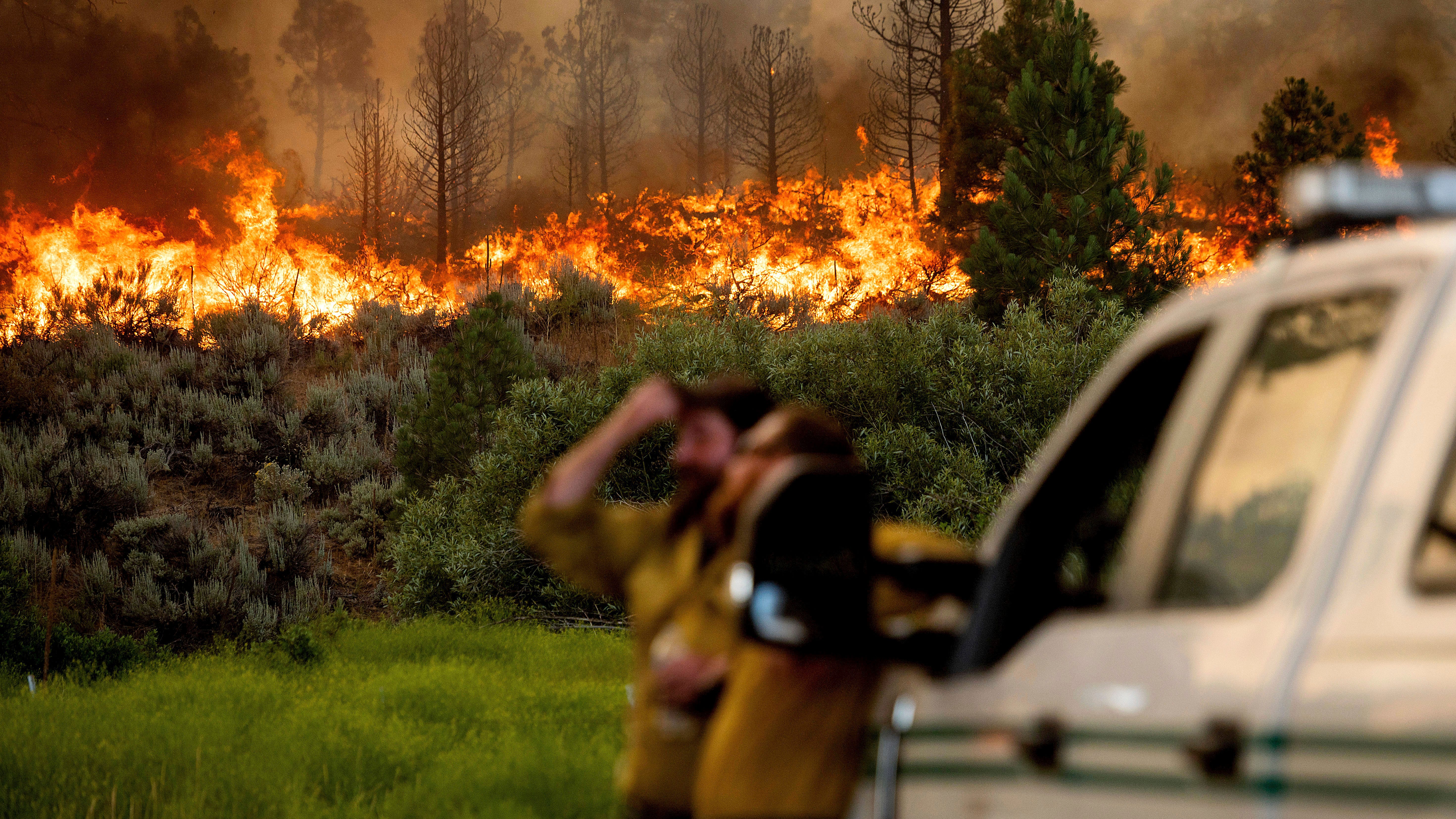 California wildfire advances as heat wave blankets US West