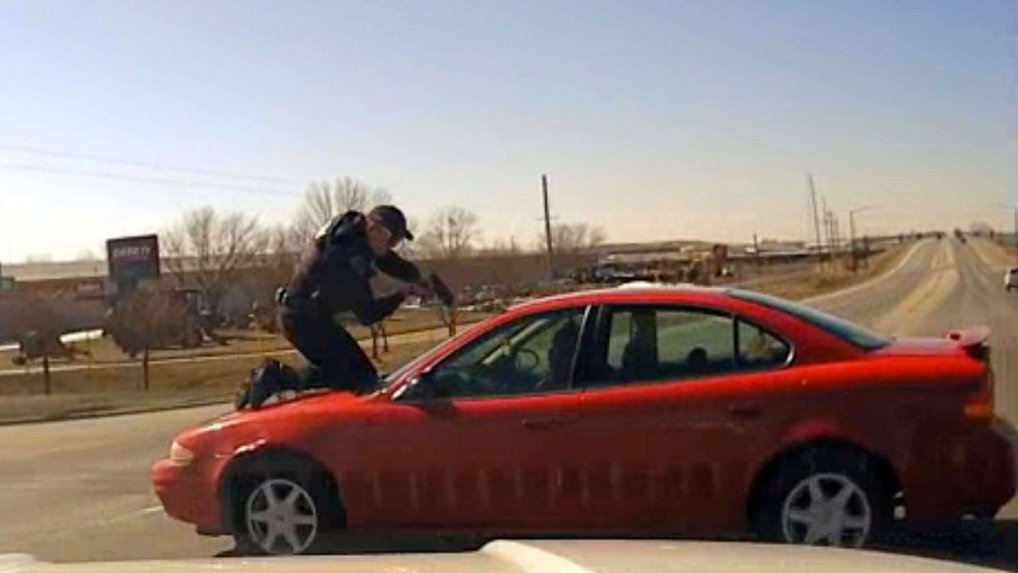Video shows driver fleeing Iowa police with officer on hood, roof of car
