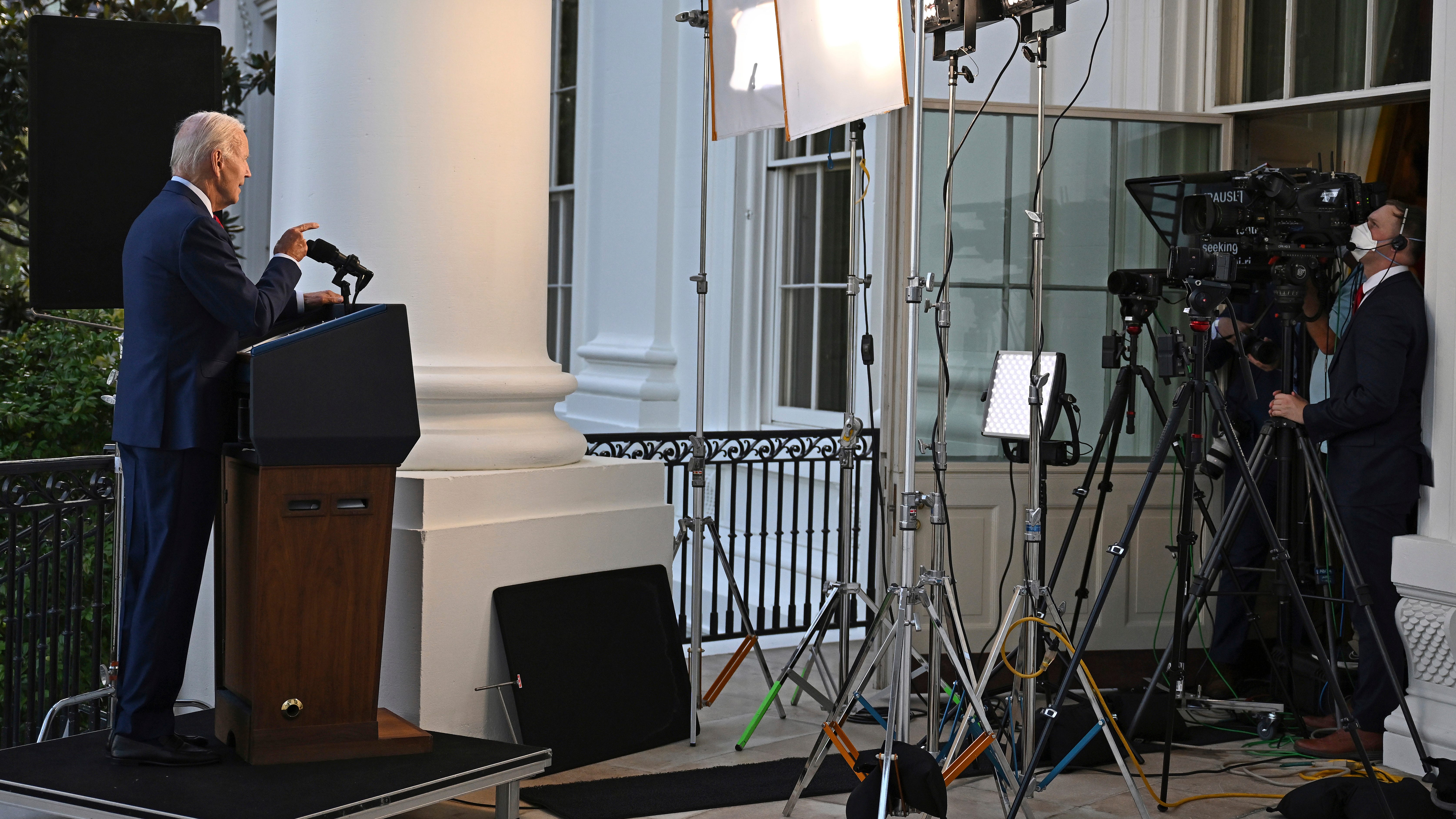 Biden's COVID sequel: back on the balcony, dog for company