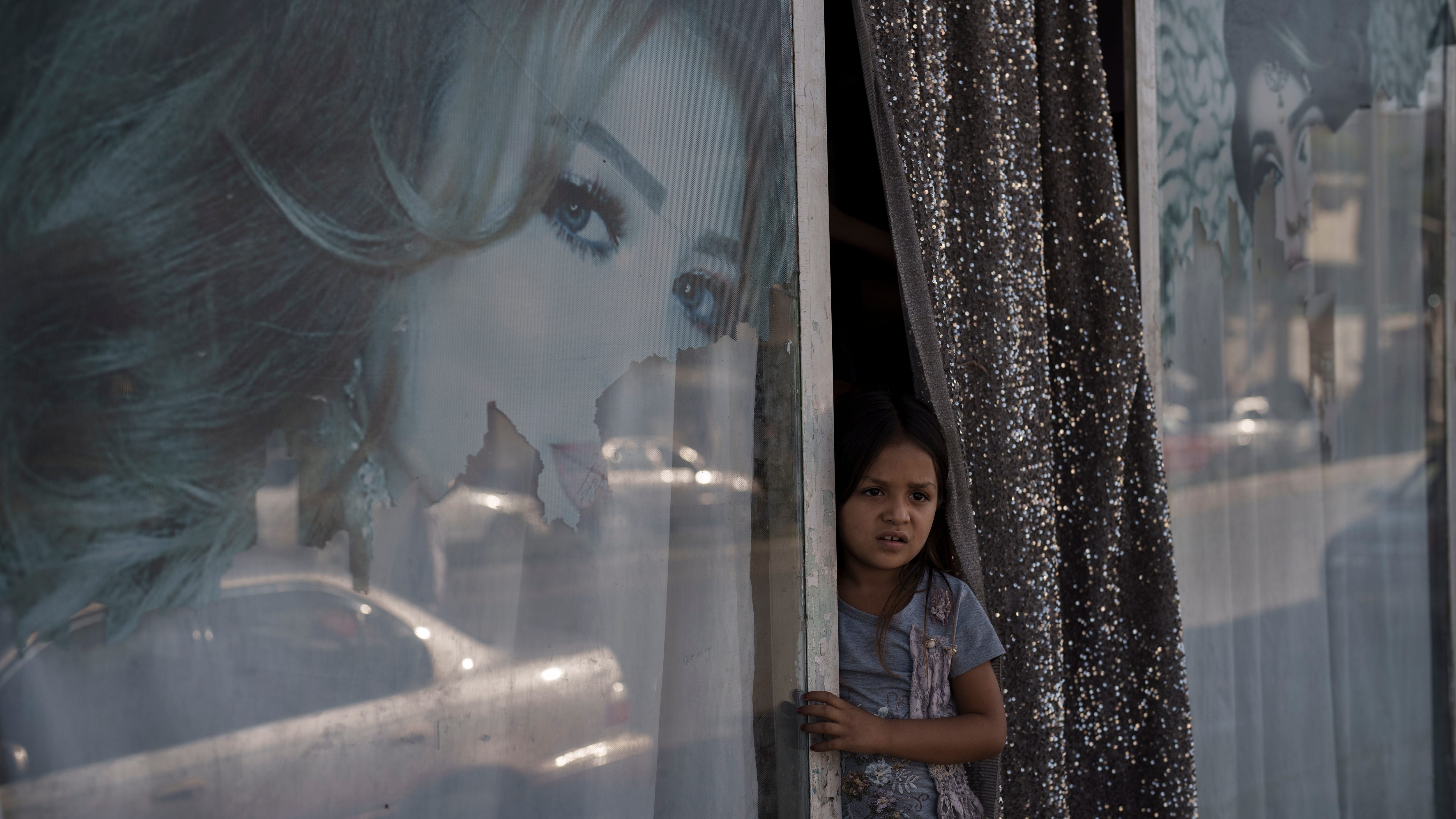 The Latest: Taliban to female Kabul city workers: Stay home