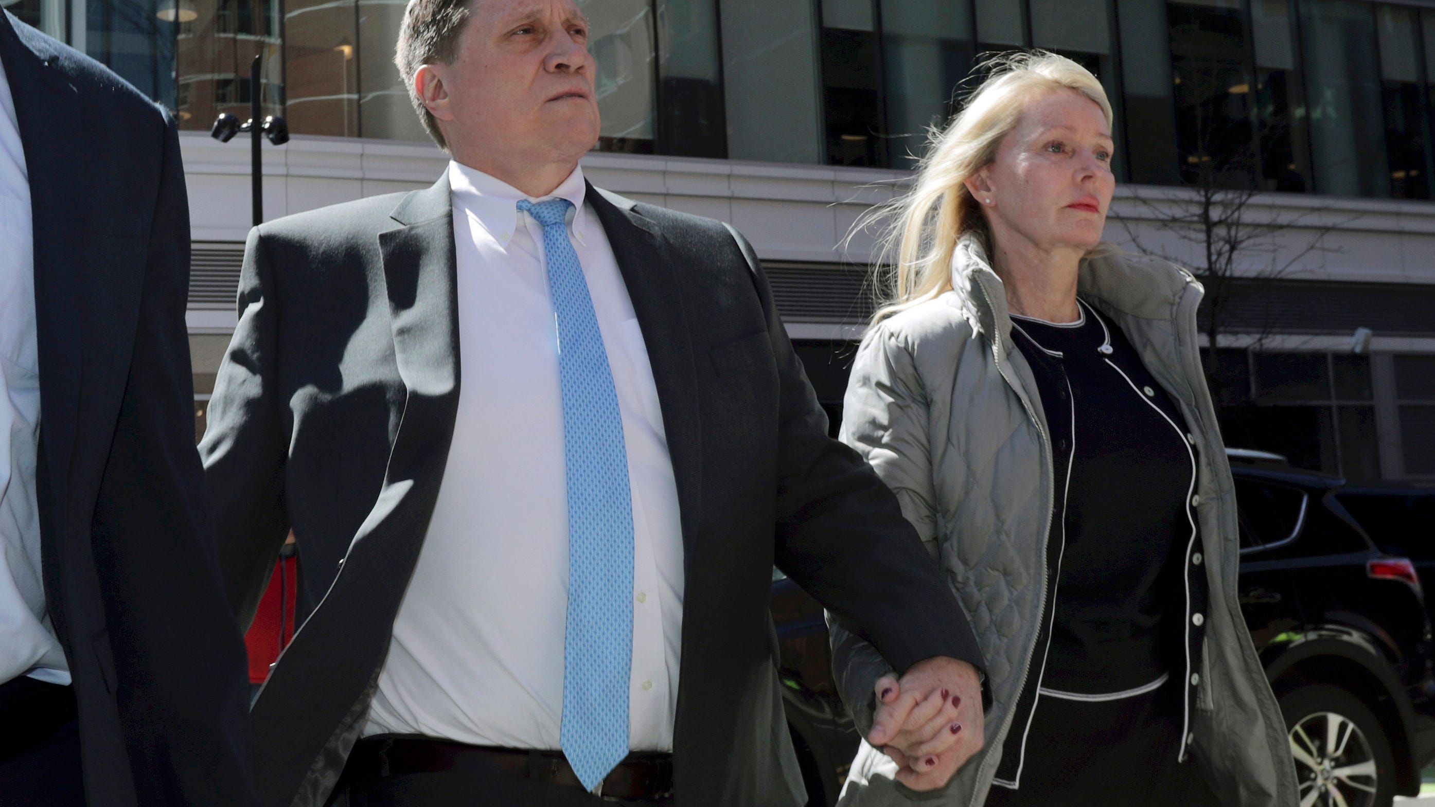 Parents convicted in college scam remain free during appeal