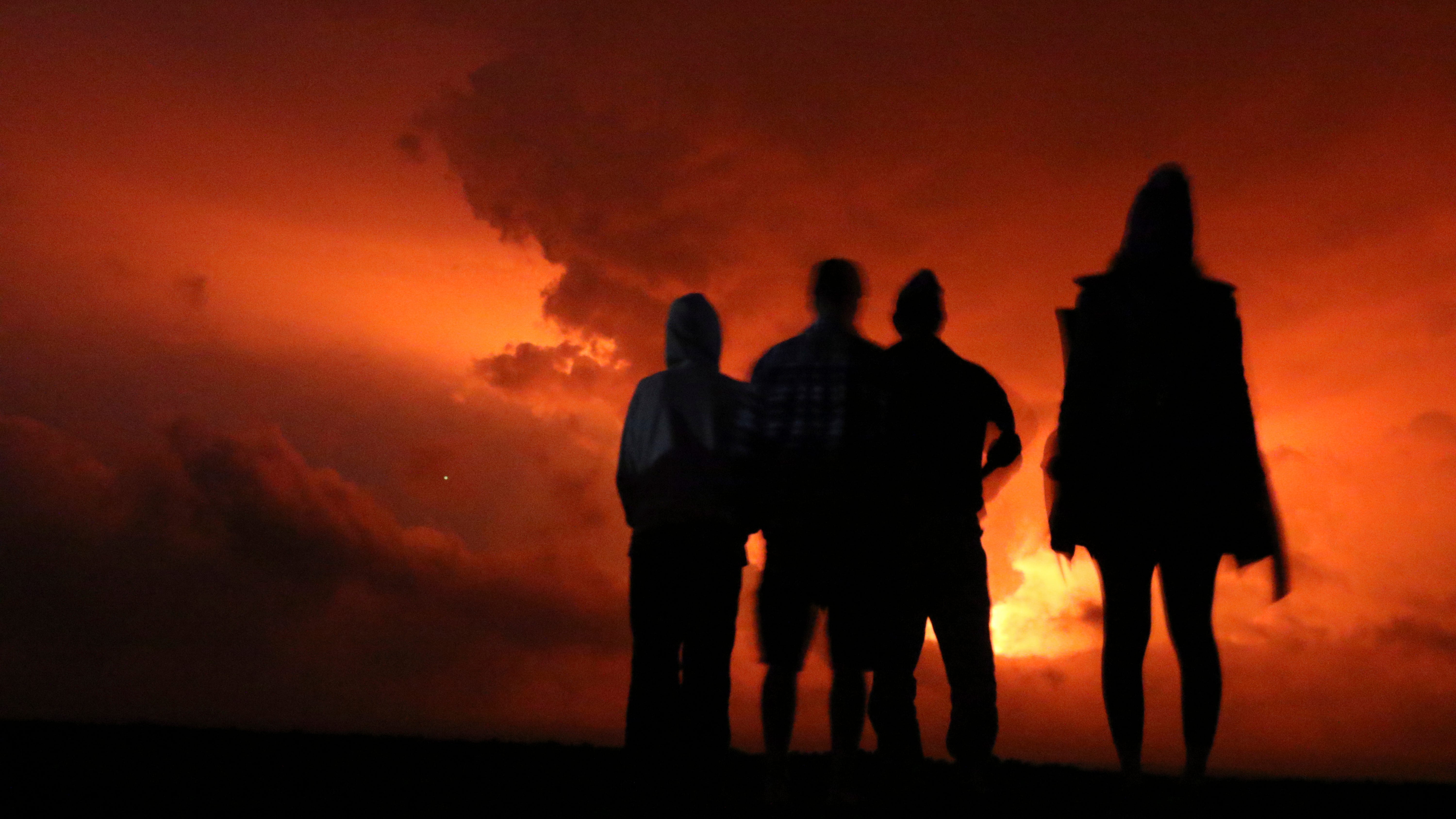 Lava from Hawaii volcano lights night sky amid warnings