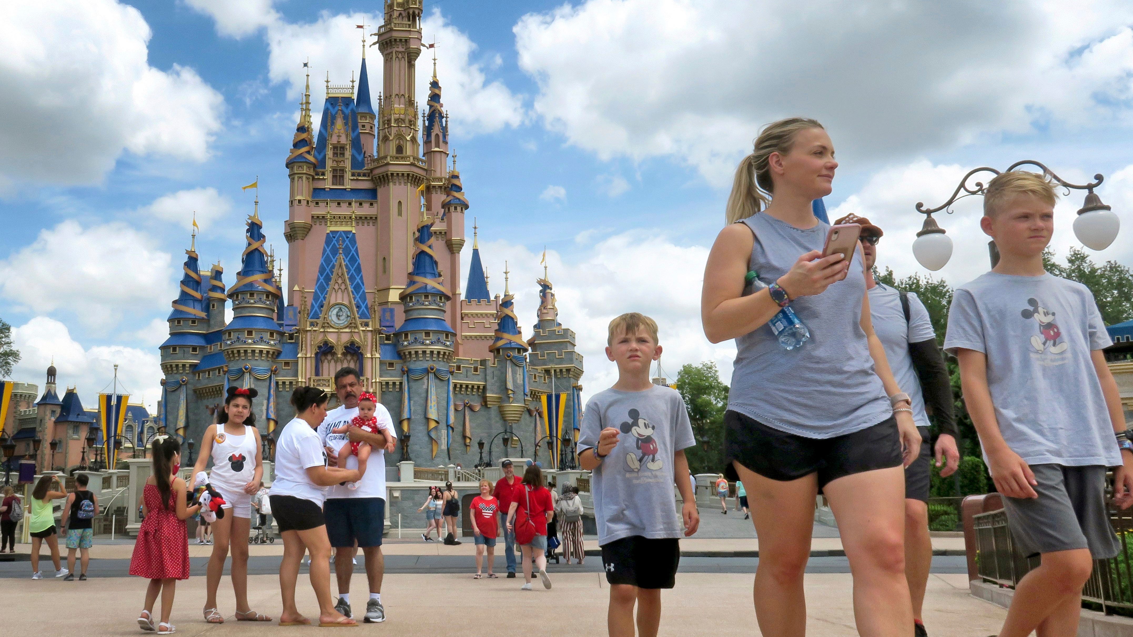 The Latest: Disney plans to restart fireworks shows at parks