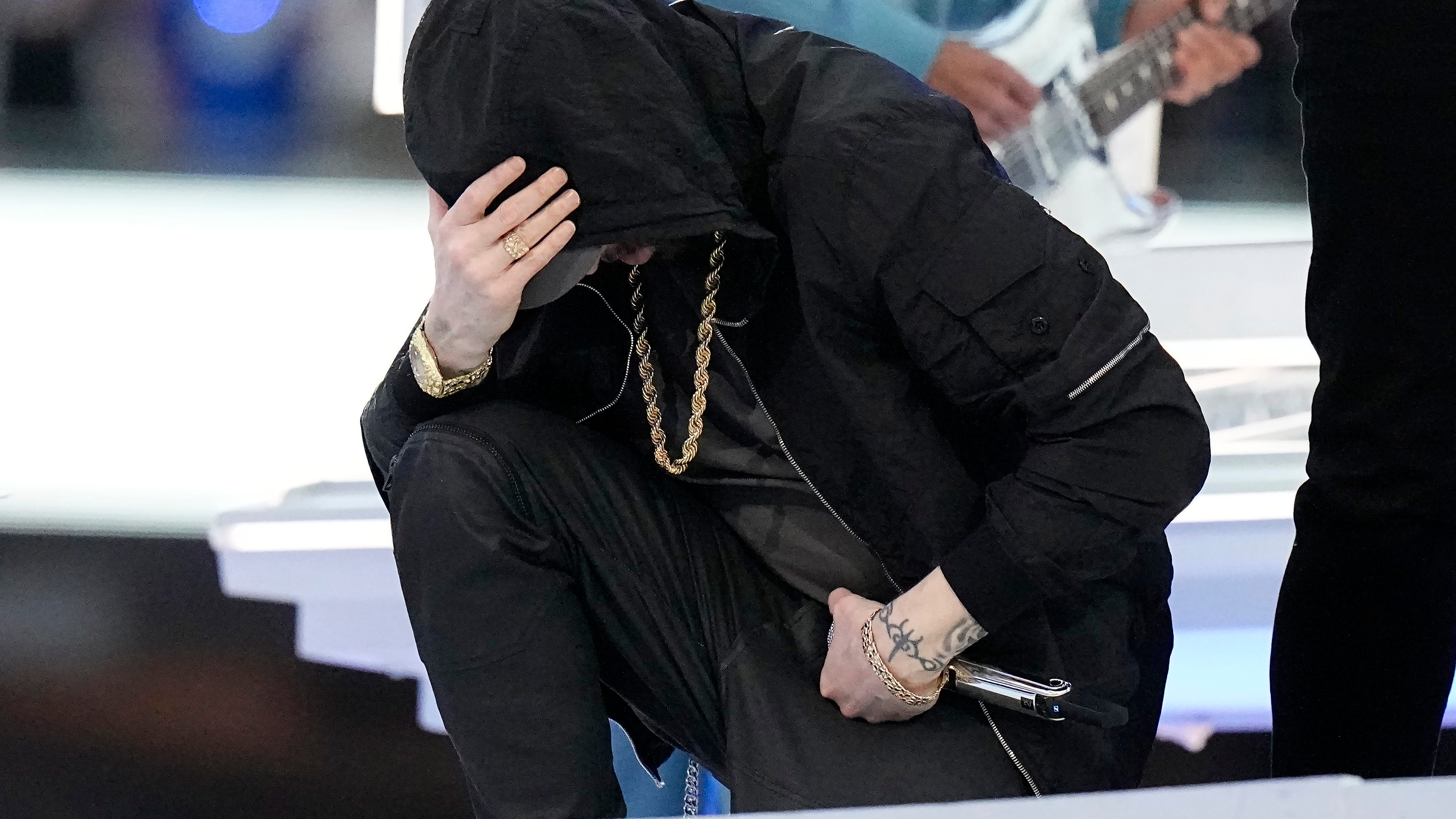 Super Bowl: Eminem takes a knee, 50 Cent hangs upside down