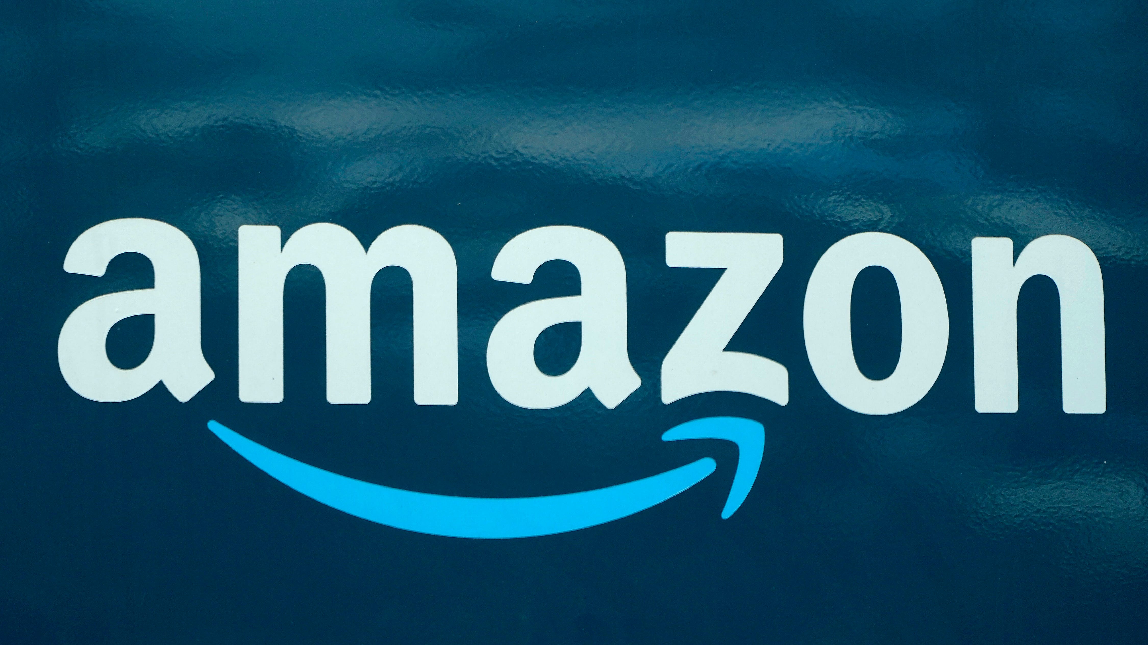 Amazon reports rare quarterly loss as online shopping slows