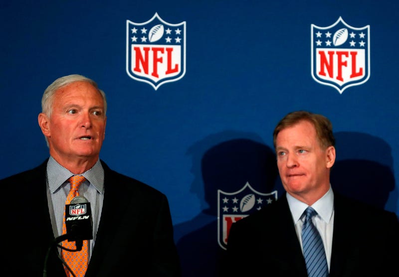 Cleveland Browns owner Jimmy Haslam speaks as NFL commissioner Roger Goodell looks on at right after they announced NFL team owners have reached agreement on a new league policy that requires players to stand for the national anthem or remain in the locke