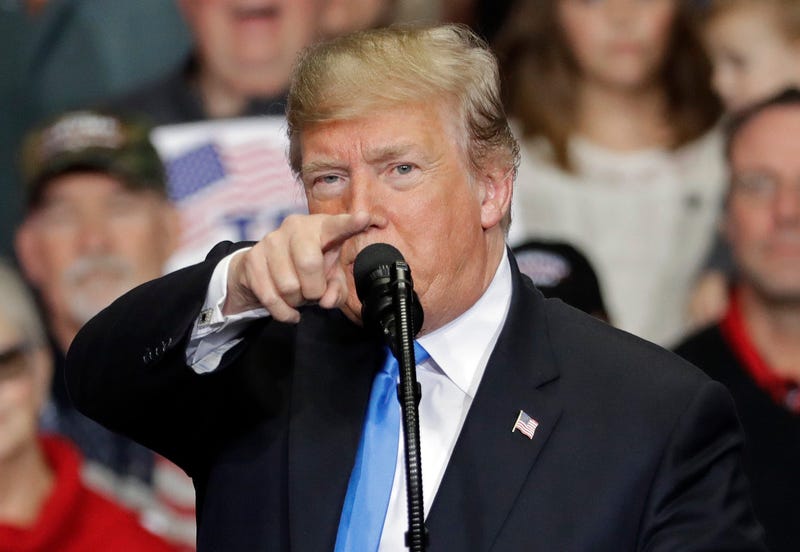 In this Oct. 26, 2018 photo, President Donald Trump points to the media as he speaks during a campaign rally in Charlotte, N.C. Trump is accusing the media of being “the true Enemy of People” in the wake of a mass shooting and a mail bomb plot.
