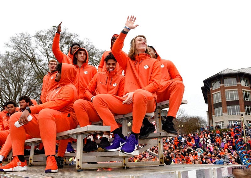 Clemson quarterback Trevor Lawrence, right, along with fellow freshman ride in the parade honoring Clemson Saturday, Jan. 12, 2019, in Clemson