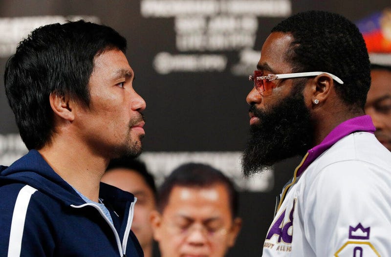 Manny Pacquiao, left, and Adrien Broner pose for photographers during a news conference Wednesday, Jan. 16, 2019, in Las Vegas.
