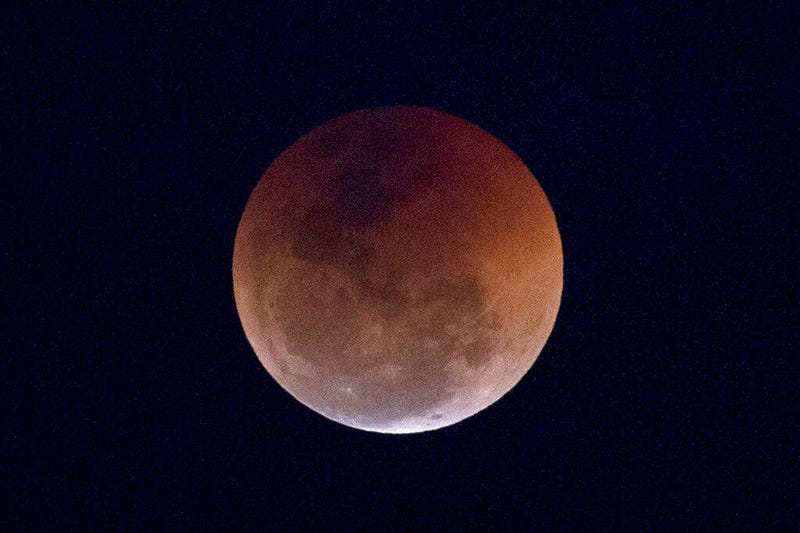 FILE - This Friday, July 27, 2018 file photo shows a blood moon lunar eclipse from the Arpoador beach in Rio de Janeiro, Brazil. Starting Sunday evening, Jan. 20, 2019, all of North and South America will be able to see the only total lunar eclipse of 201