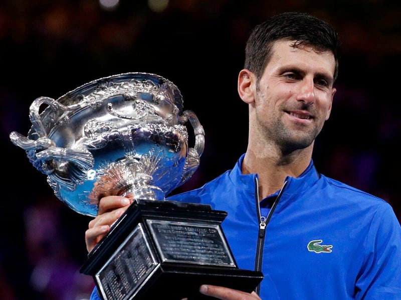 Serbia's Novak Djokovic holds his trophy after defeating Spain's Rafael Nadal in the men's singles final at the Australian Open tennis championships