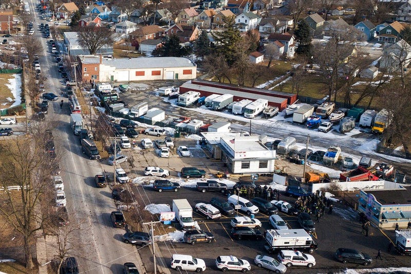 Law enforcement personnel gather near the scene of a shooting at an industrial park in Aurora, Ill., on Friday, Feb. 15, 2019.