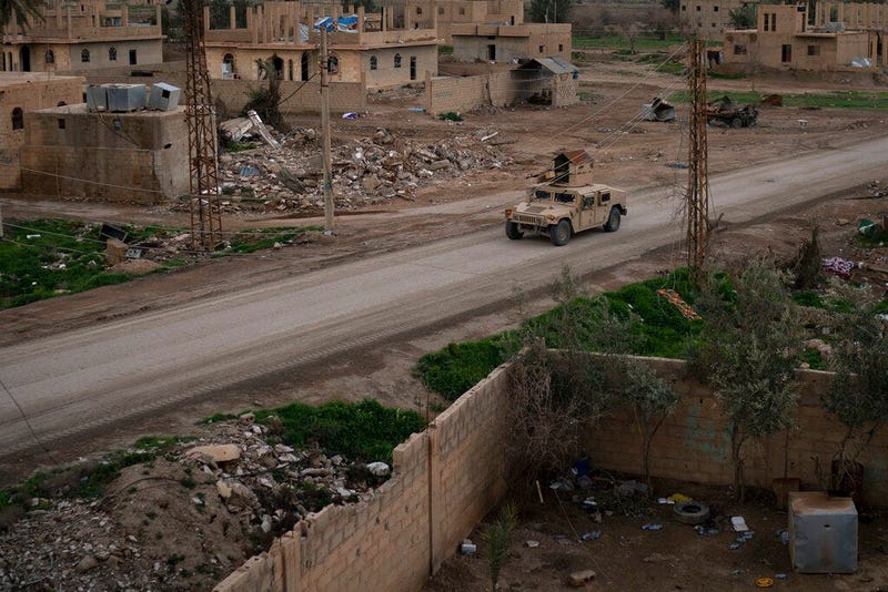 A Humvee drives in a village recently retaken from Islamic State militants by U.S.-backed Syrian Democratic Forces (SDF) near Baghouz, Syria, Sunday, Feb. 17, 2019