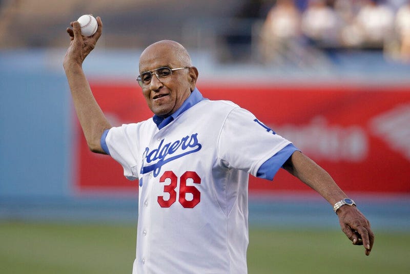 former Los Angeles Dodgers pitcher Don Newcombe throws a ceremonial pitch before a baseball game between the Los Angeles Dodgers and the Cleveland Indians, in Los Angeles.