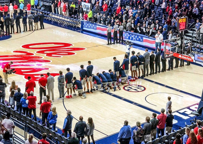 Six Mississippi basketball players take a knee during the national anthem before an NCAA college basketball game against Georgia in Oxford, Miss., Saturday, Feb. 23, 2019.