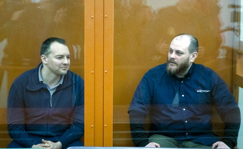 The former chief of the cybercrime department at Russia's main domestic security agency Sergei Mikhailov, left, and the former employee of Kaspersky Lab cybersecurity firm Ruslan Stoyanov attend a hearing in a court in Moscow, Russia, Tuesday, Feb. 26, 20
