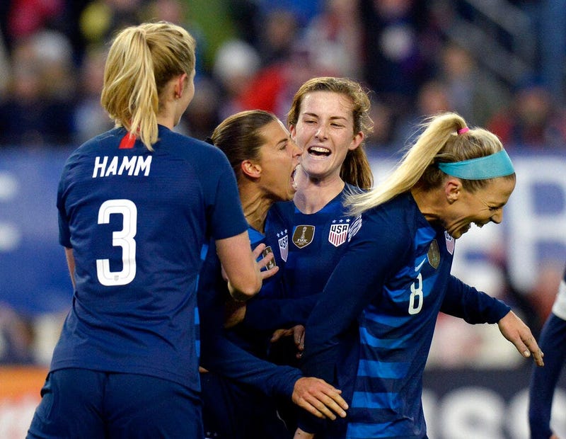 United States forward Tobin Heath, center, celebrates with teammates after scoring a goal against England during the second half of a SheBelieves Cup women's soccer match